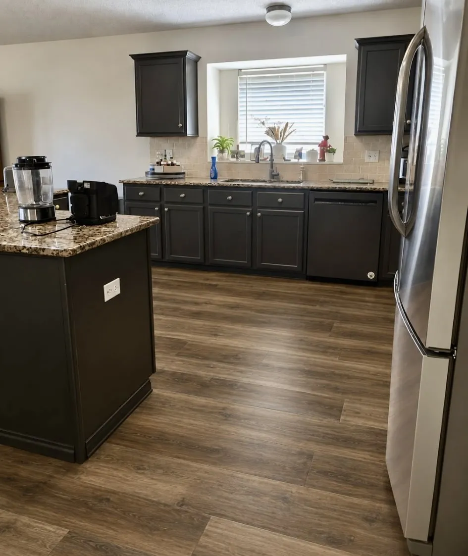 Seller to install new flooring throughout entire downstairs, upon closing of acceptable offer. Buyer can pick color and must use sellers preferred flooring vendor. AI rendition of  new luxury vinyl plank!