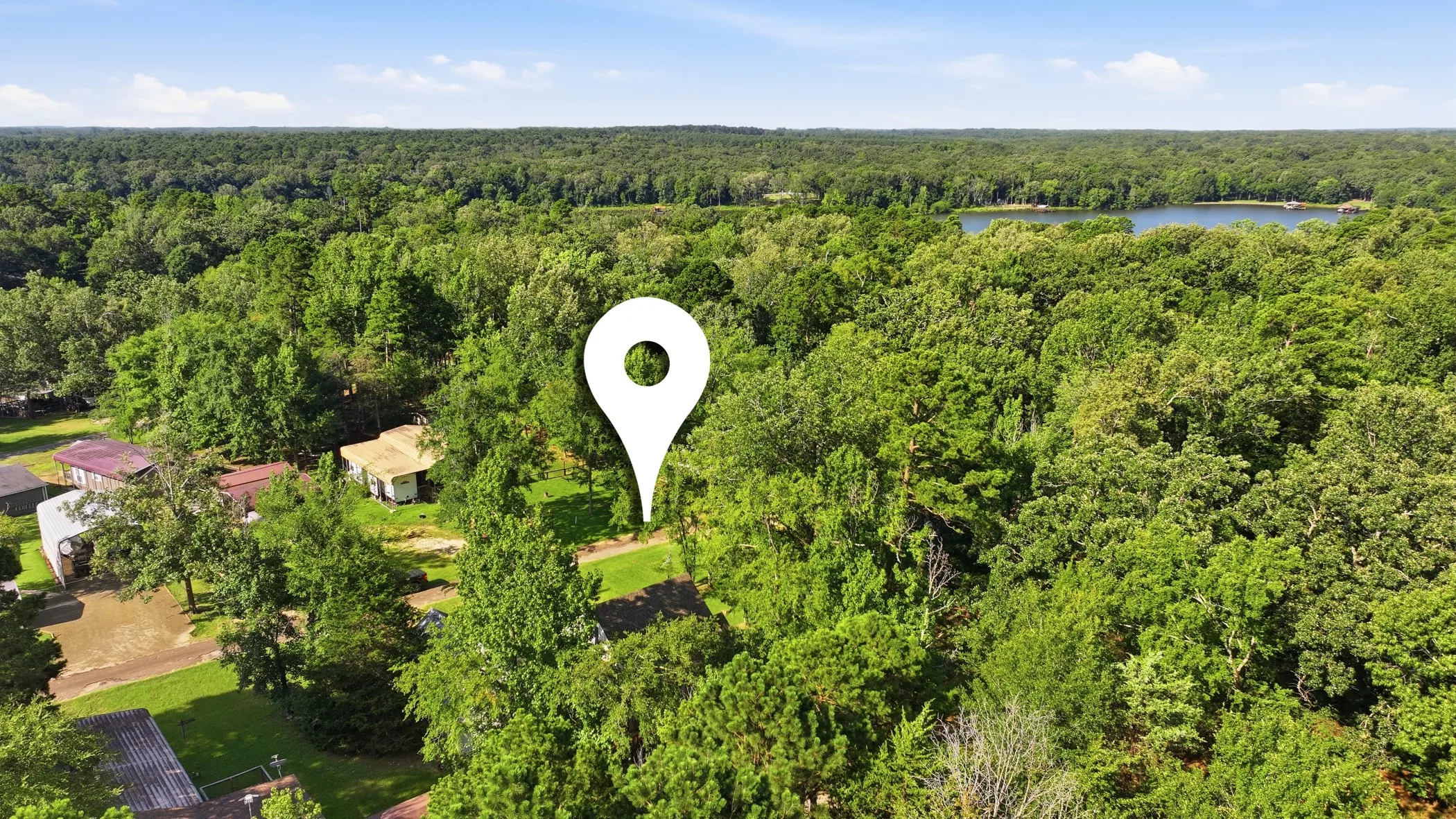 Aerial property view showcasing extensive tree coverage