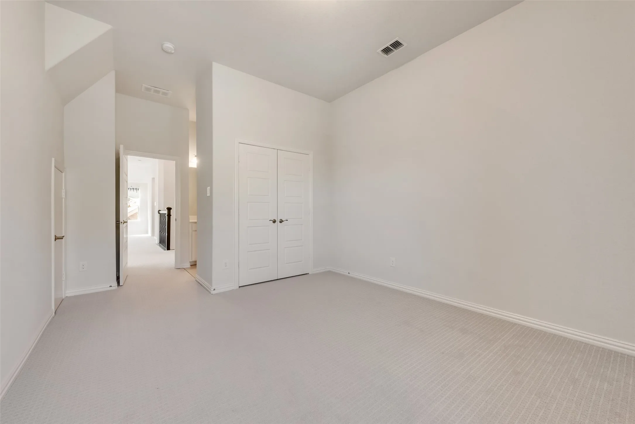 Neutral tone walls with light-colored carpeting