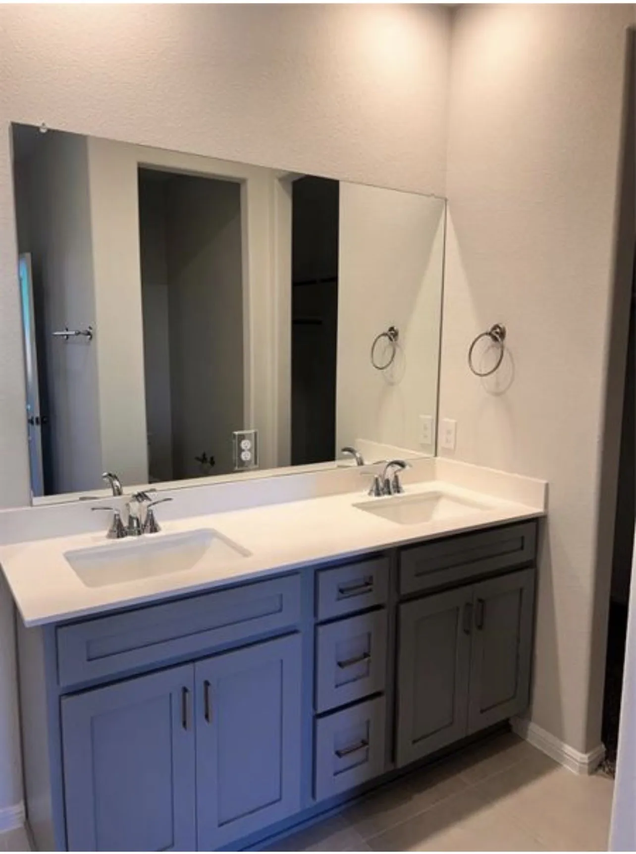 Dual vanity featuring light-toned cabinetry and a continuous countertop