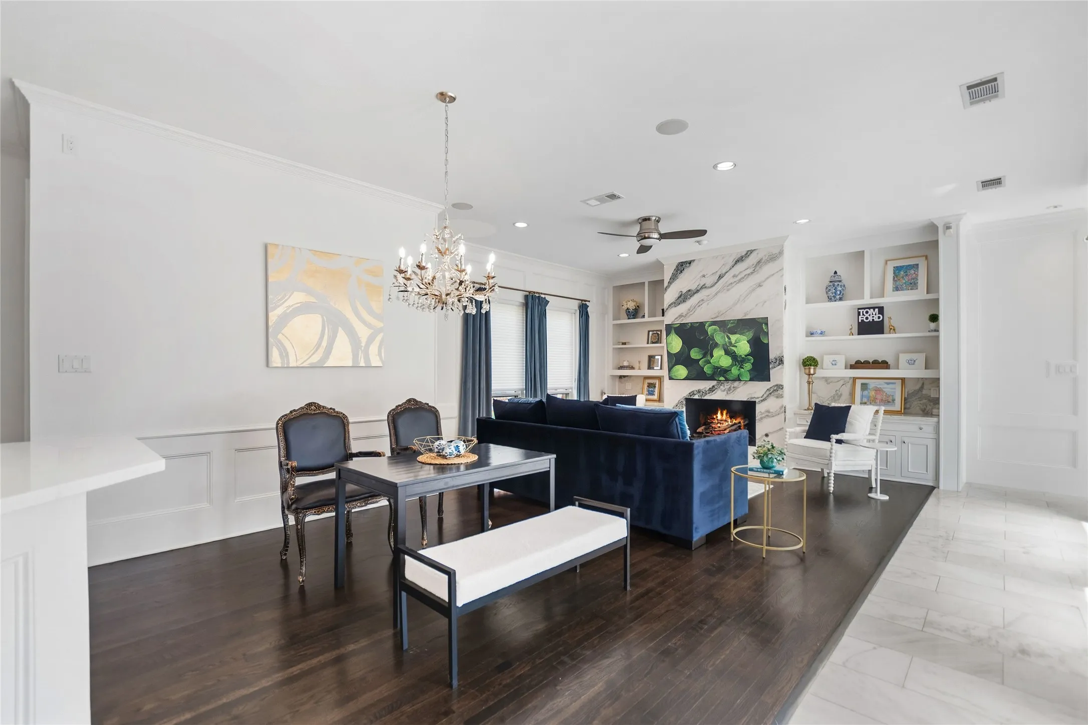 Open-concept living space featuring dark wood-finish flooring and crown molding