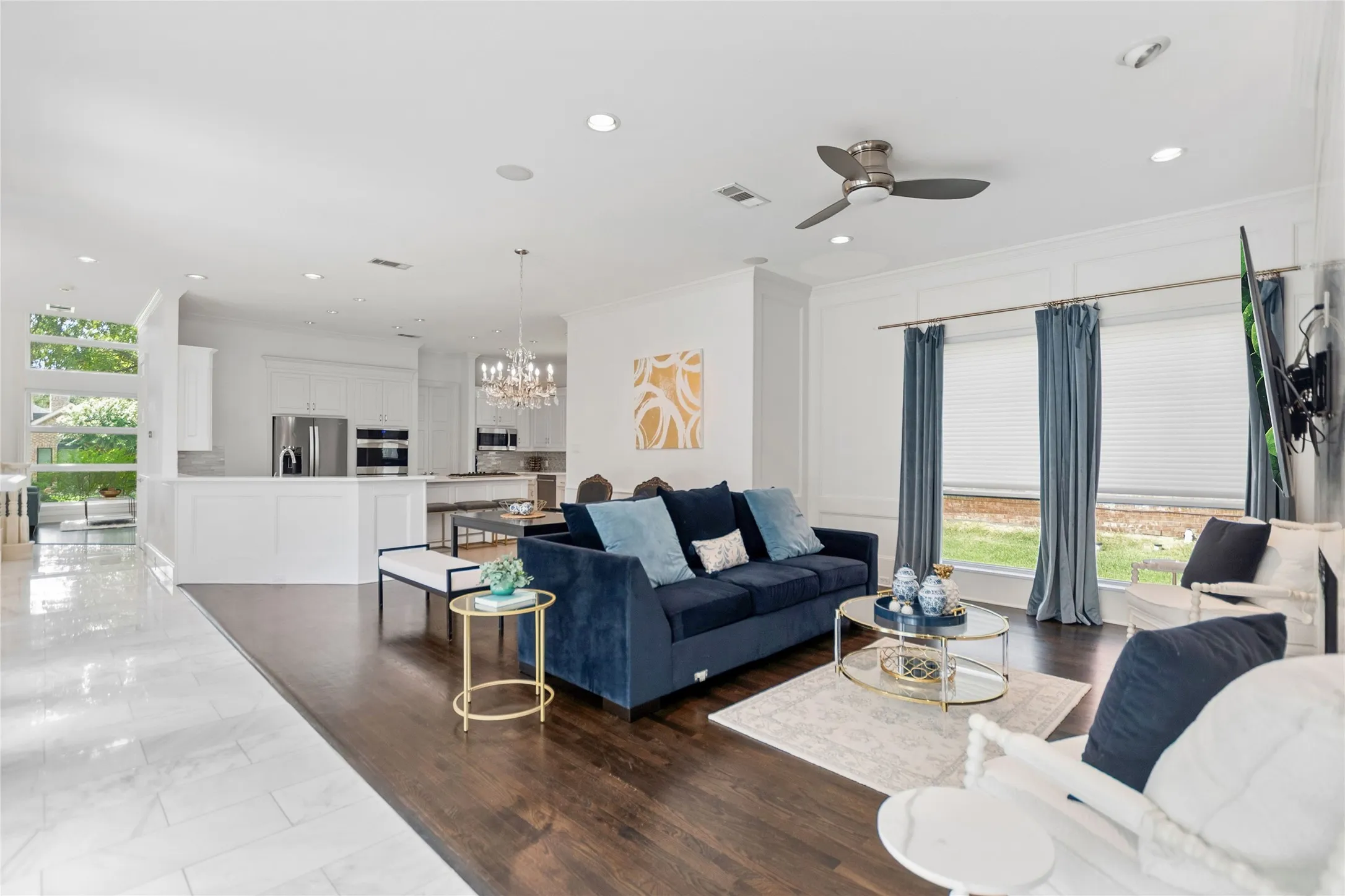 Open-concept living area featuring rich wood-finish flooring and recessed lighting