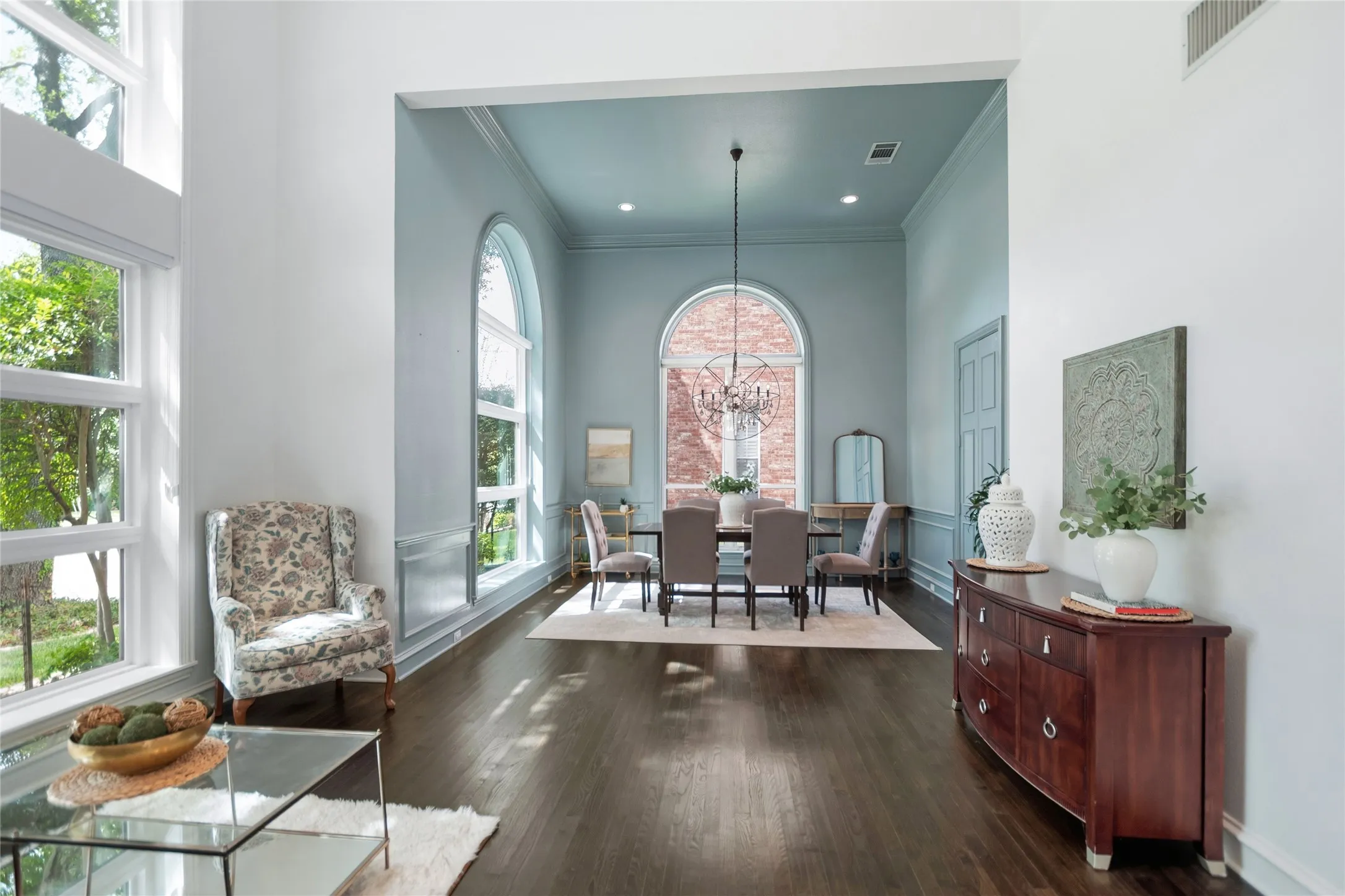 Grand entry and dining area featuring dark wood-finish flooring