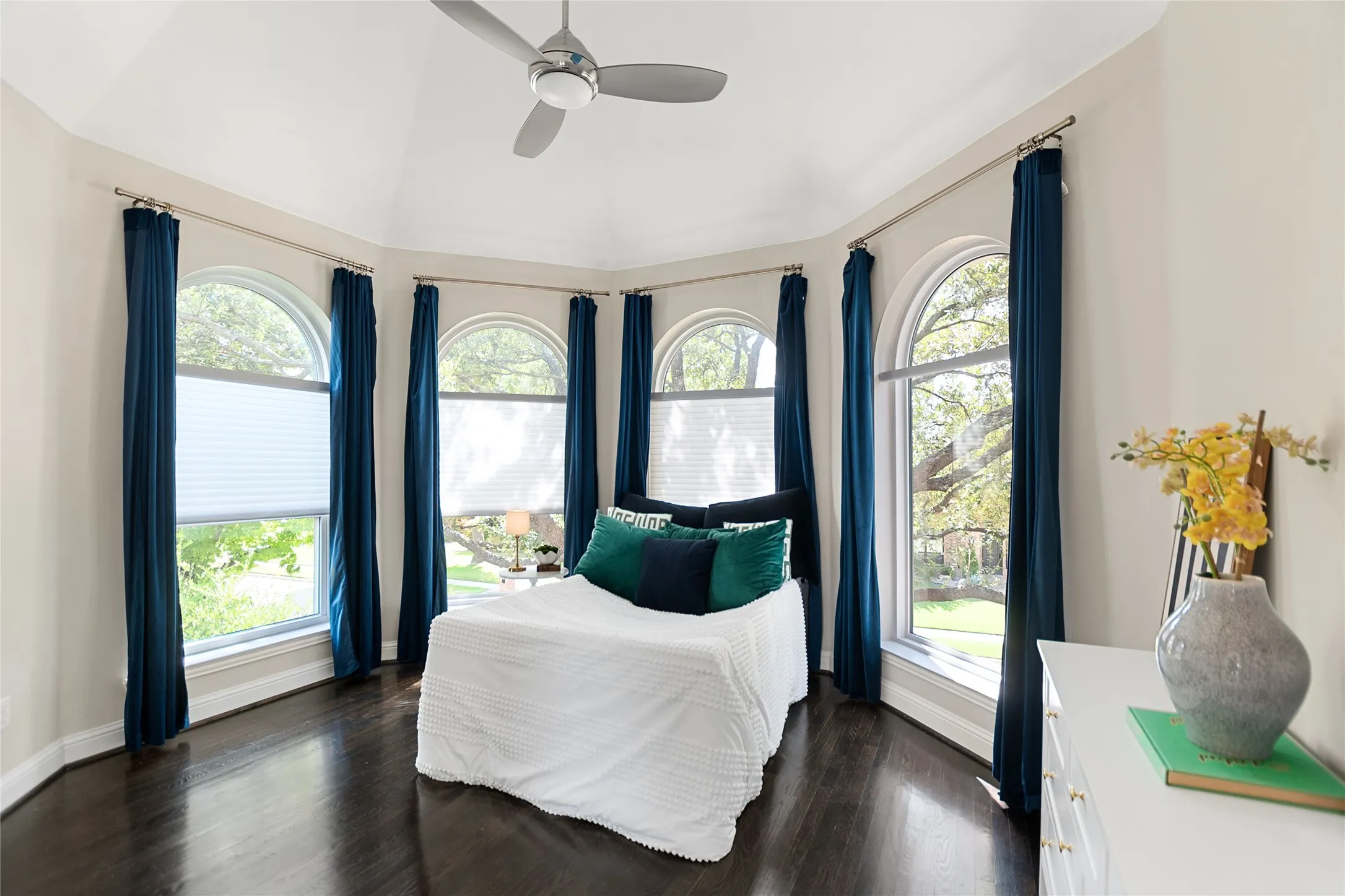 Room featuring a vaulted ceiling and dark wood-finish flooring