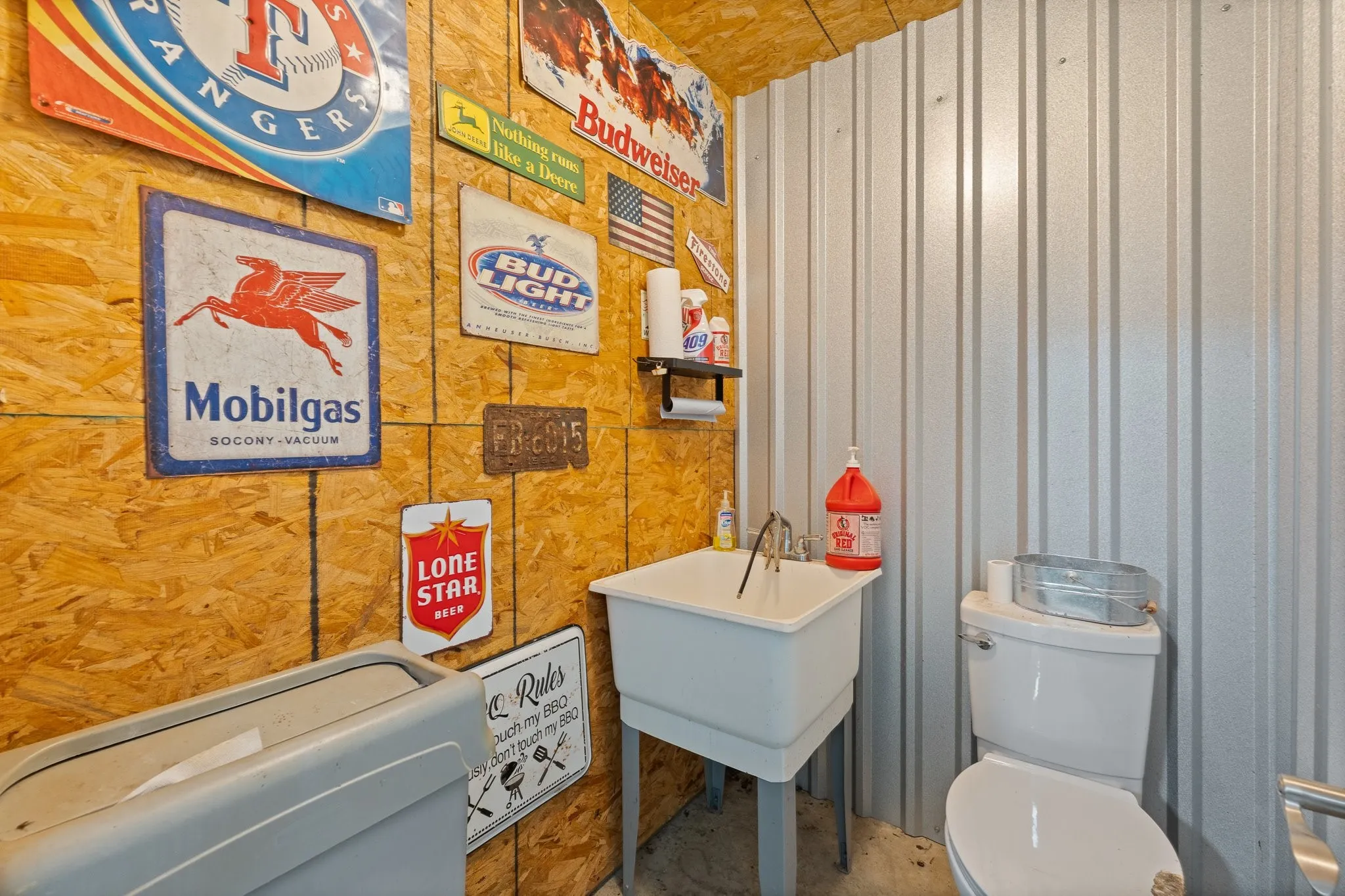 Interior space featuring oriented strand board walls and corrugated metal paneling