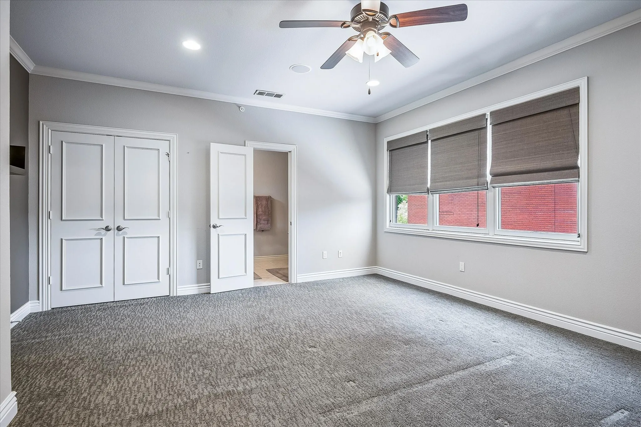 Bedroom above the garage has its own ensuite full bathroom with shower. Closet. Crown molding. Window overlooks courtyard. This room would be a great home office or another living area, whatever new owner wishes.
