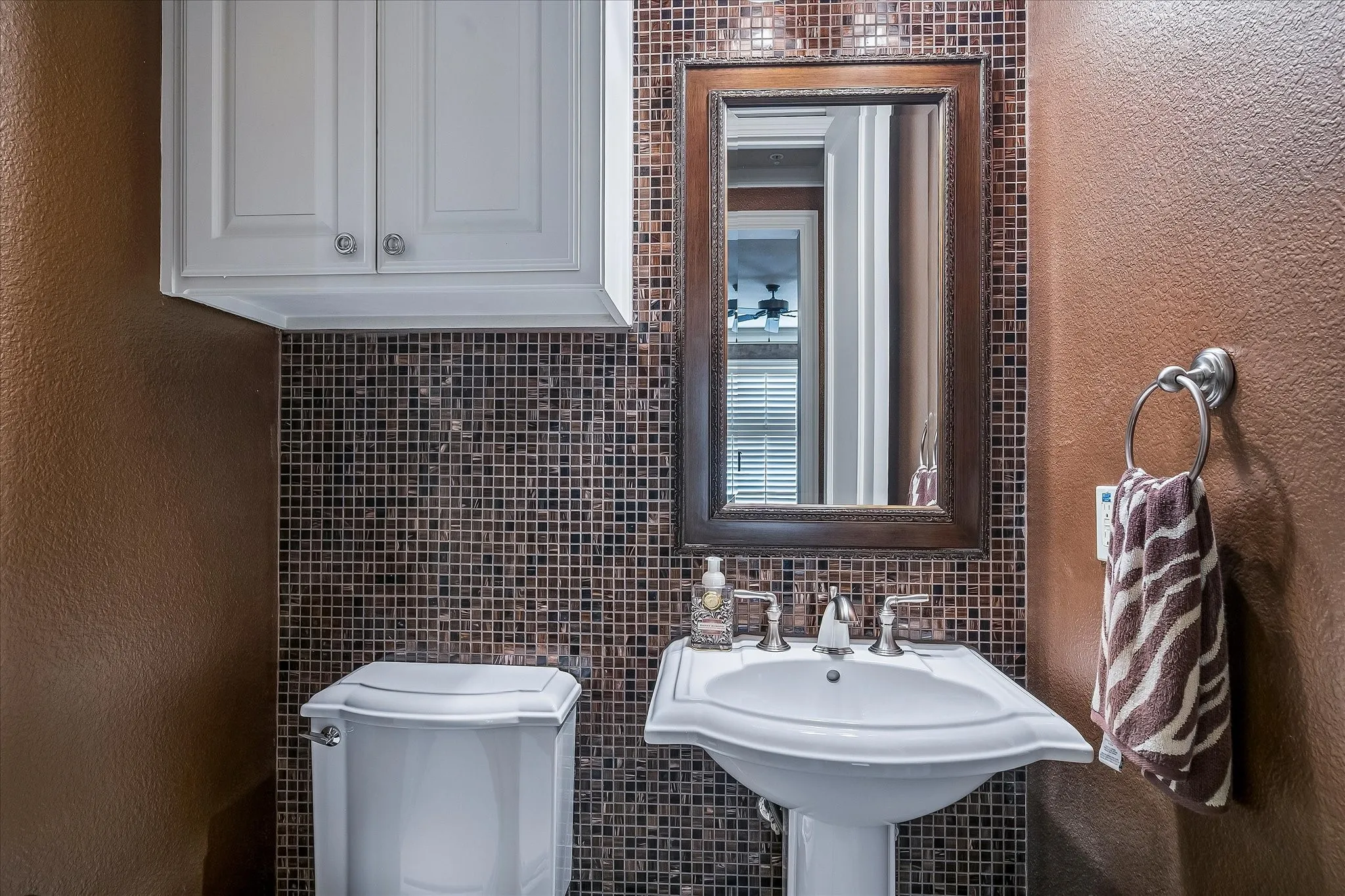 Half bath off the game room, tiled accent wall.