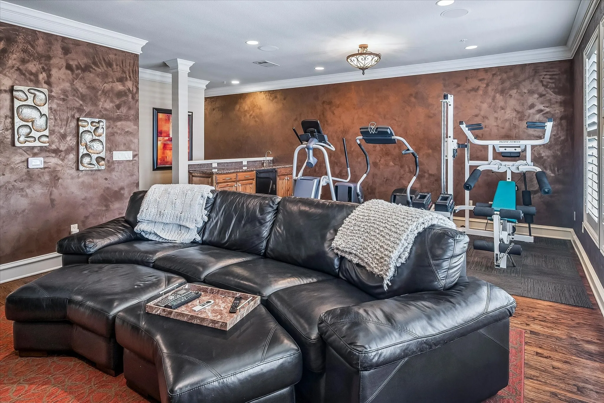 Another view of the game room, wet bar, plenty of room for exercise equipment or whatever new owner would like to use this room for.