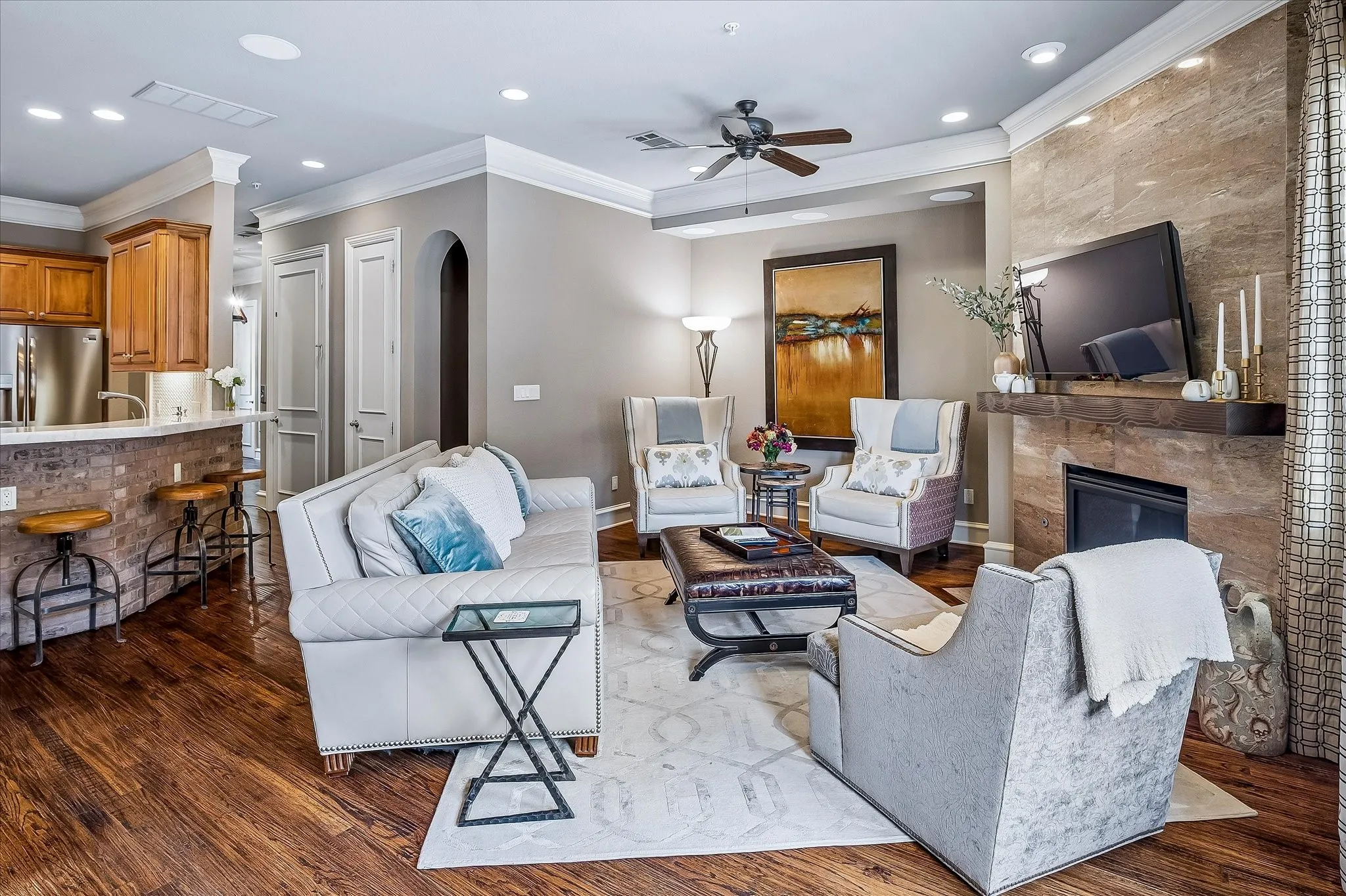 Beautiful tile wall surrounds the fireplace, wood mantle.