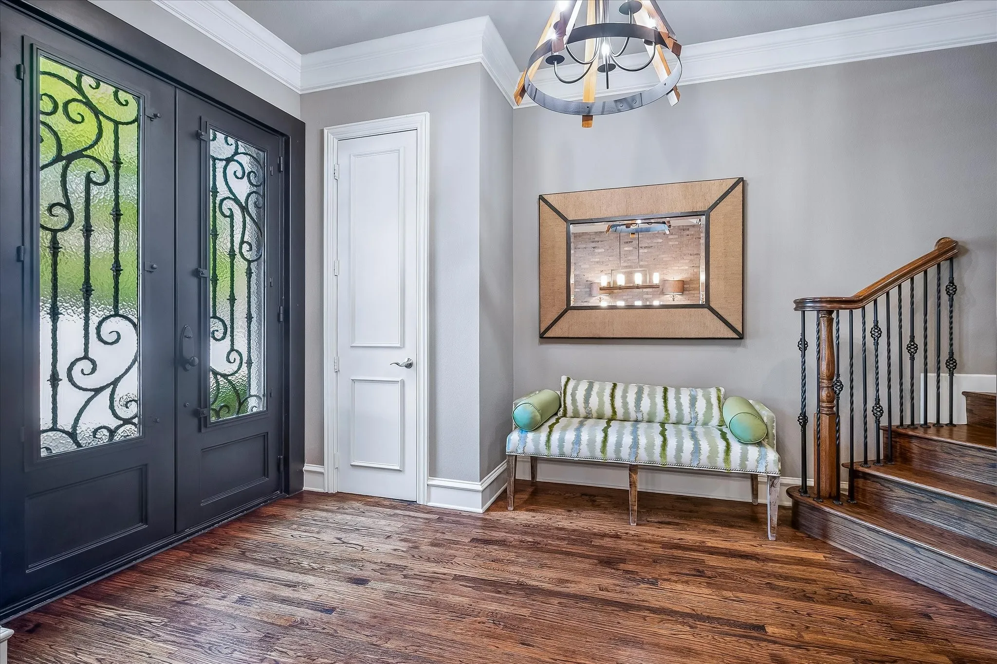 Large entry area with closet at front door. Handscraped floors, oversized crown molding and baseboards. Custom lighting throughout.