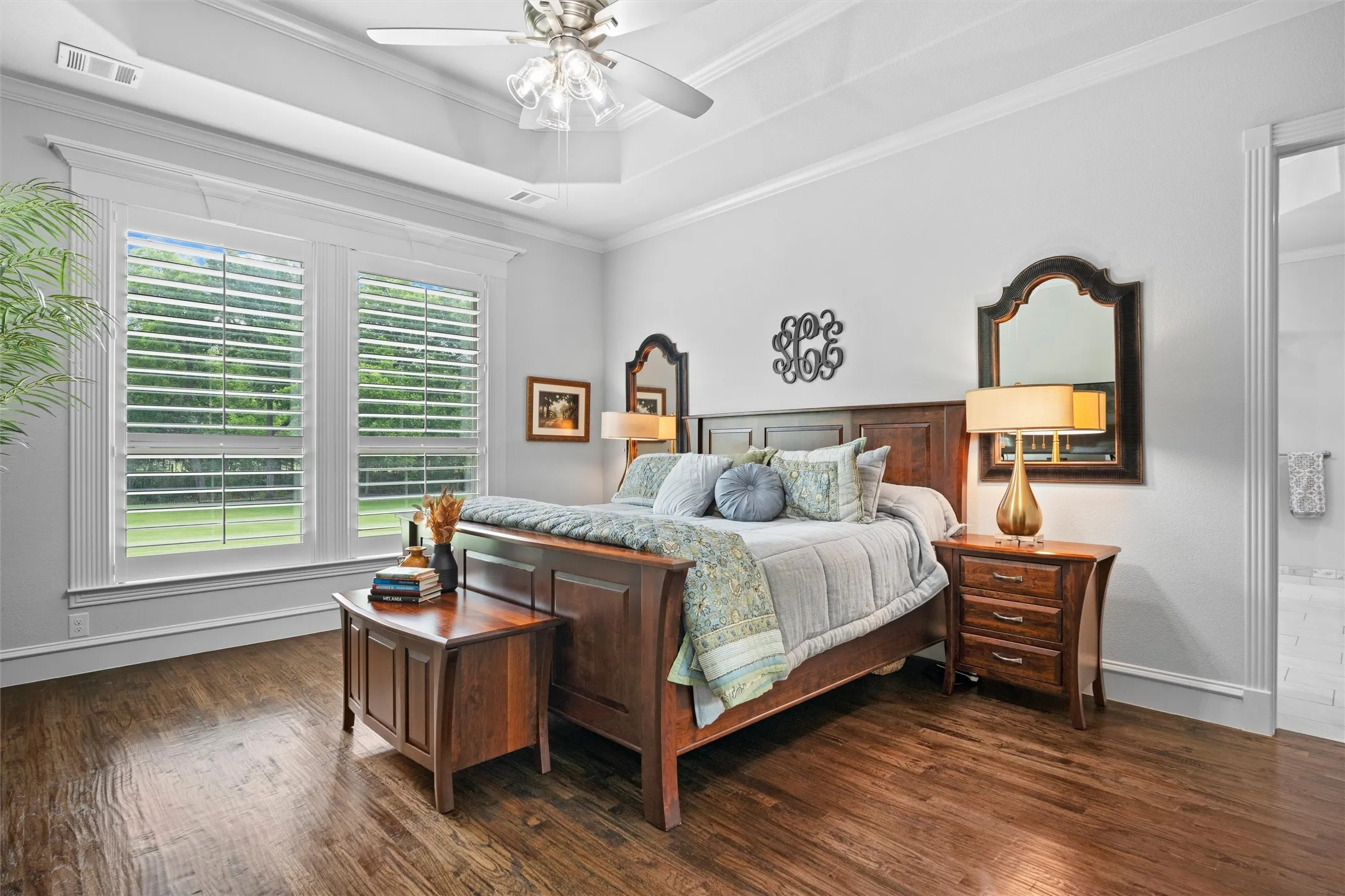 Primary suite with breathtaking views of the backyard, custom trim everywhere and those gorgeous wood floors