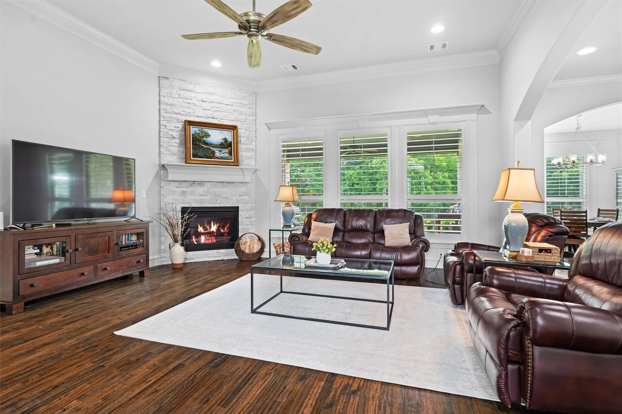 Your main living area is open to the foyer, kitchen, breakfast/dining area. Notice the custom trim around every window and door in the home, along with custom shutters.
