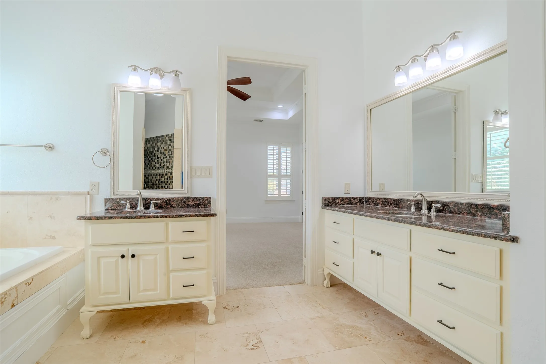 Travertine flooring in the primary bath