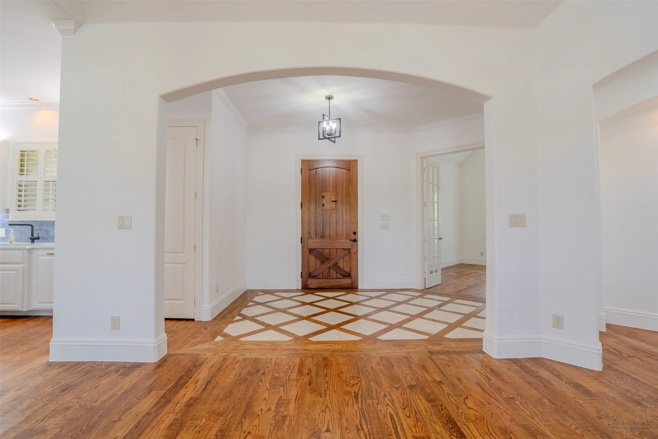 Entry way with peek-a-boo window in the solid wood door.