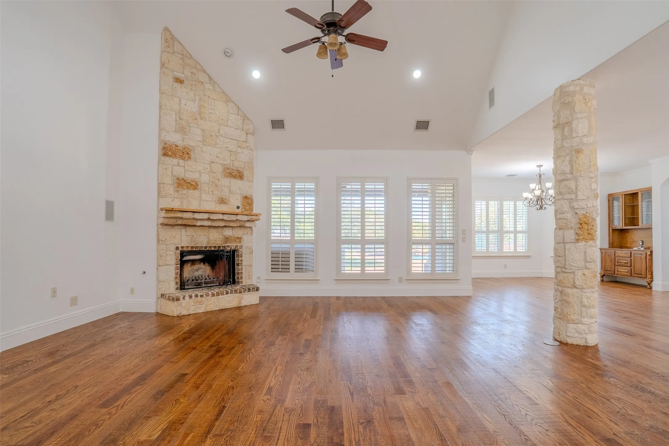 Living room with tall ceilings and hand scraped hardwood flooring