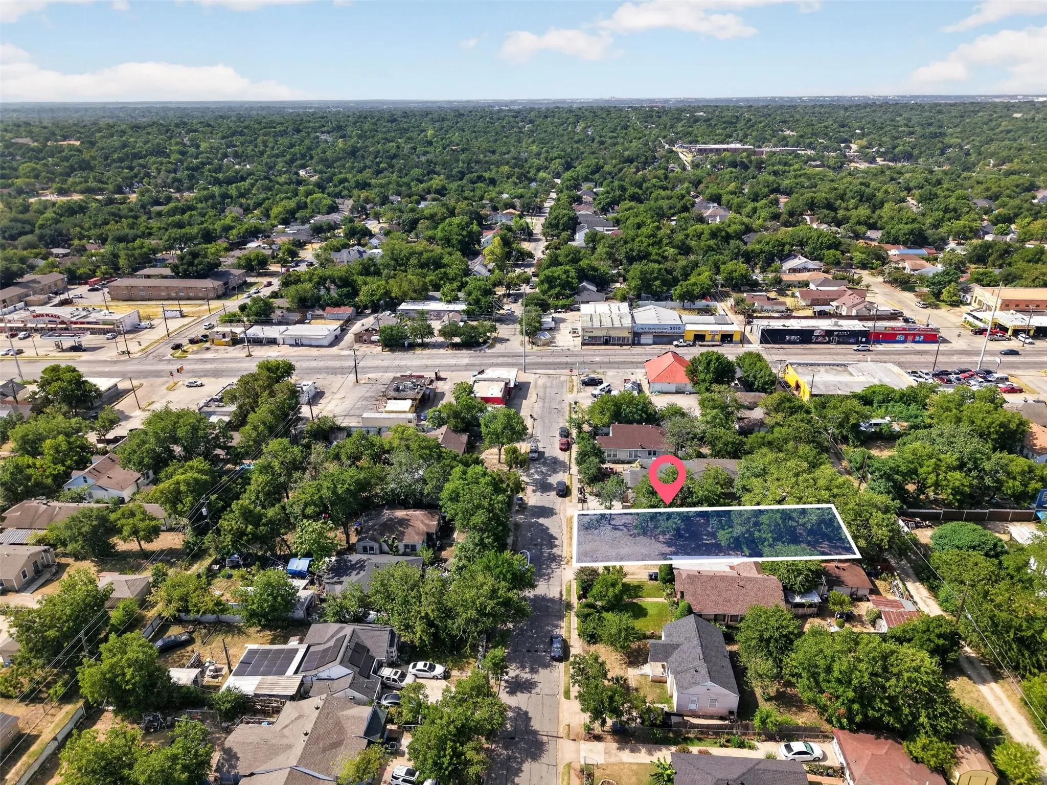 Aerial perspective of a verdant neighborhood with residential properties and tree-lined streets