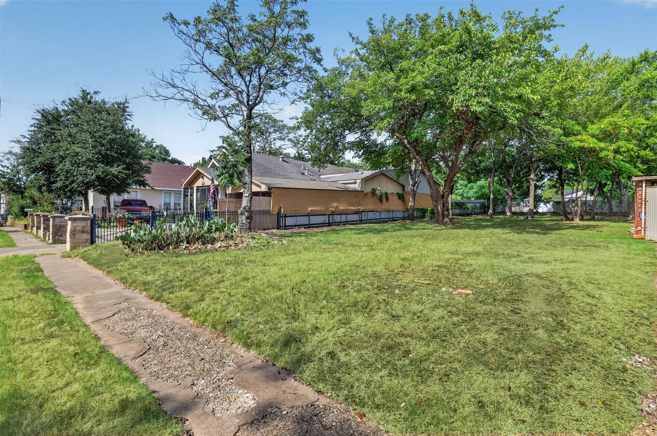 Expansive, level lot featuring mature trees and a substantial grassy area