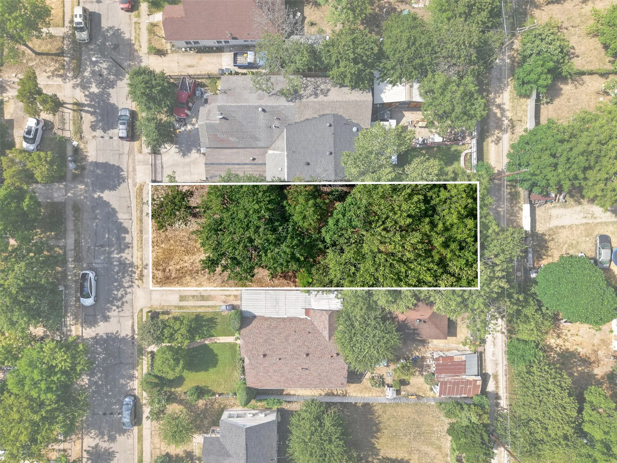Rectangular parcel featuring mature trees and clear land