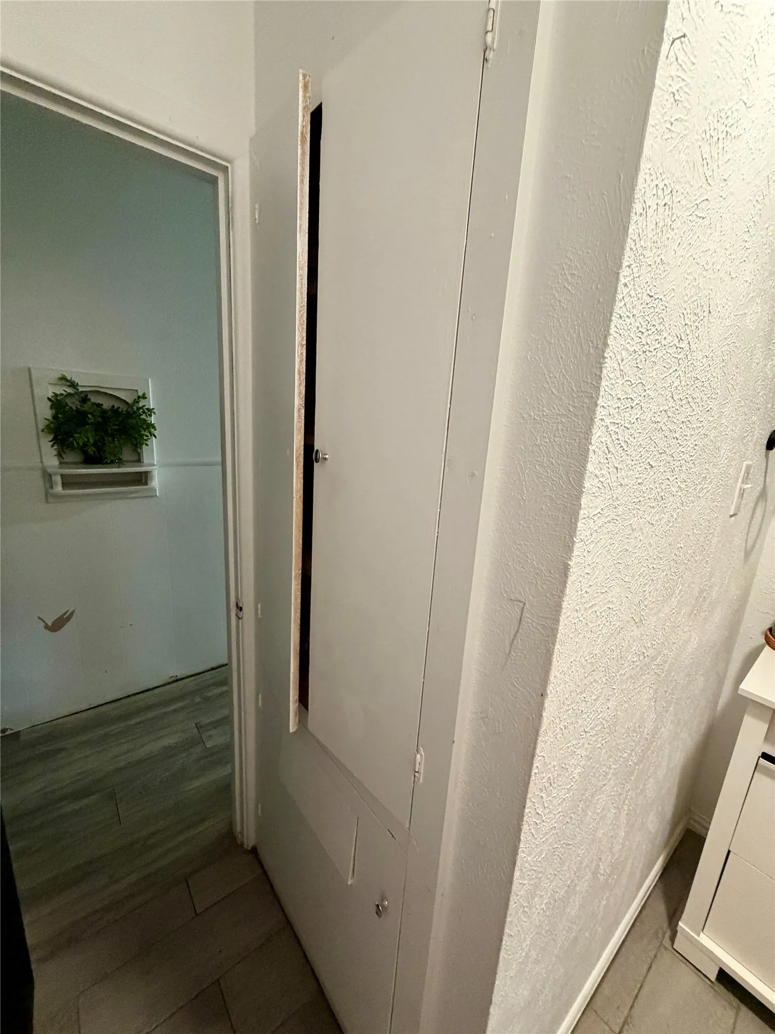 Linen cabinet with built in clothes hamper in secondary bathroom