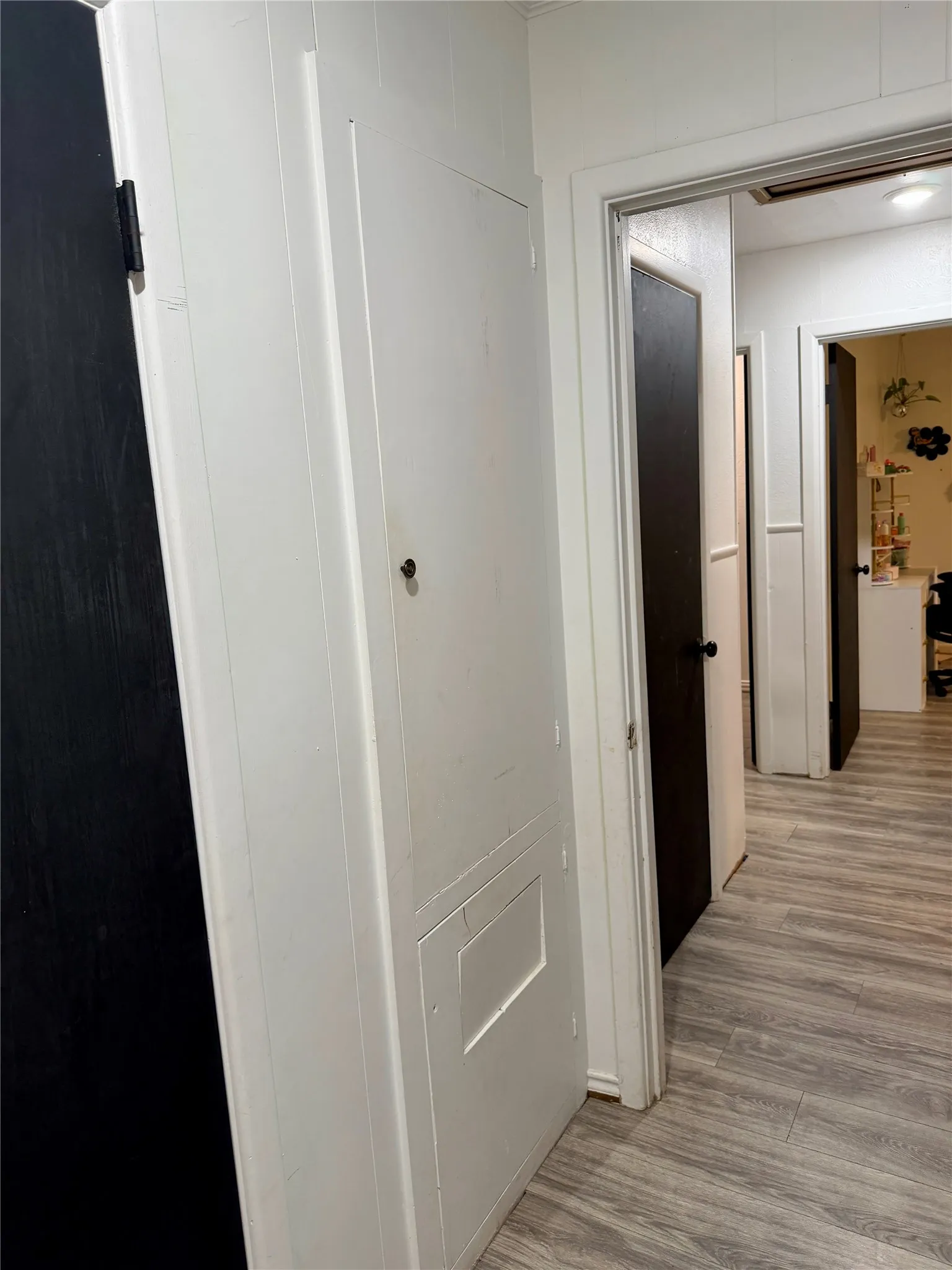 Storage cabinet in primary bedroom with clothes hamper