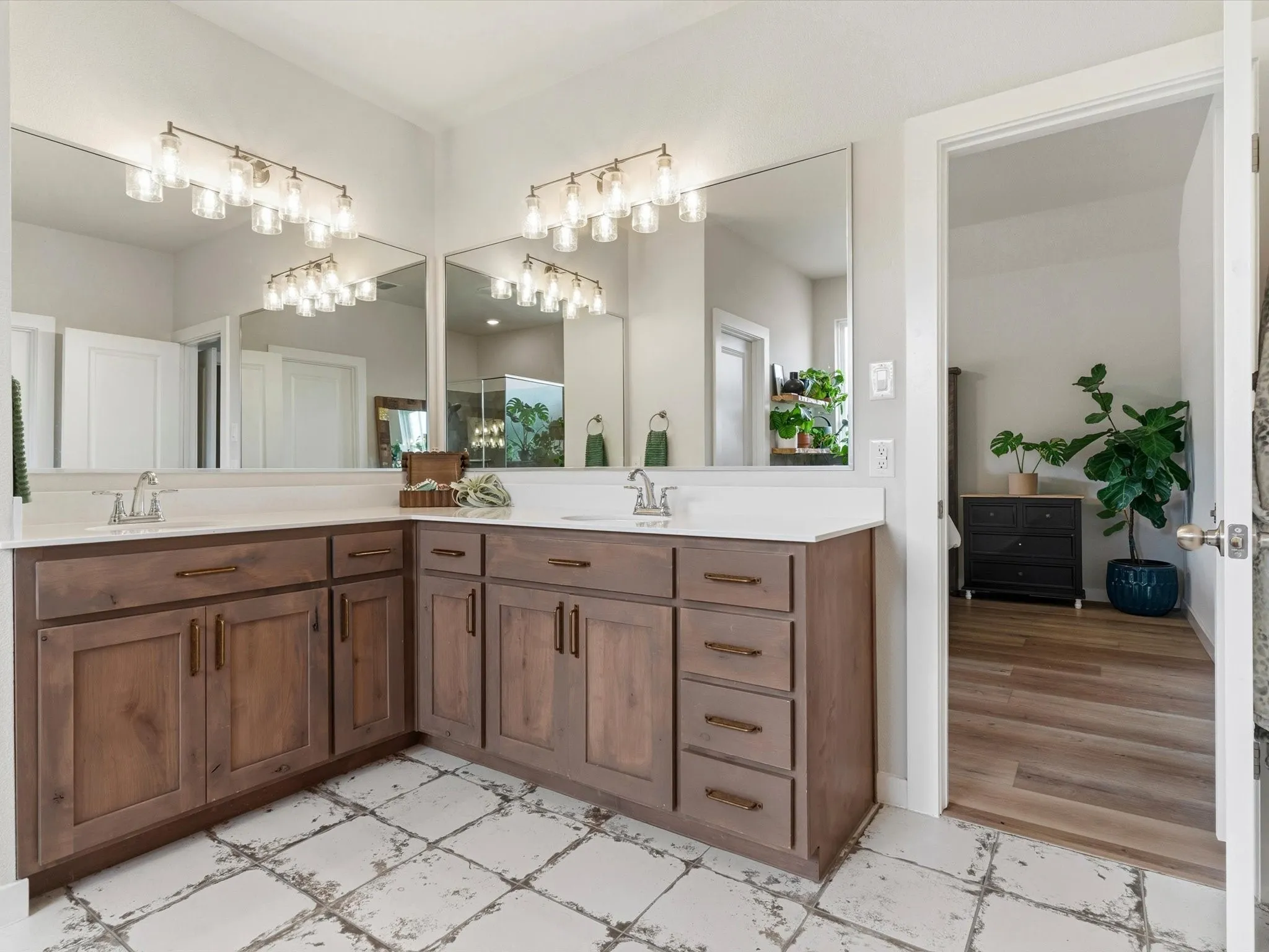Well-appointed primary bath featuring dual vanities, spacious shower, and functional design.