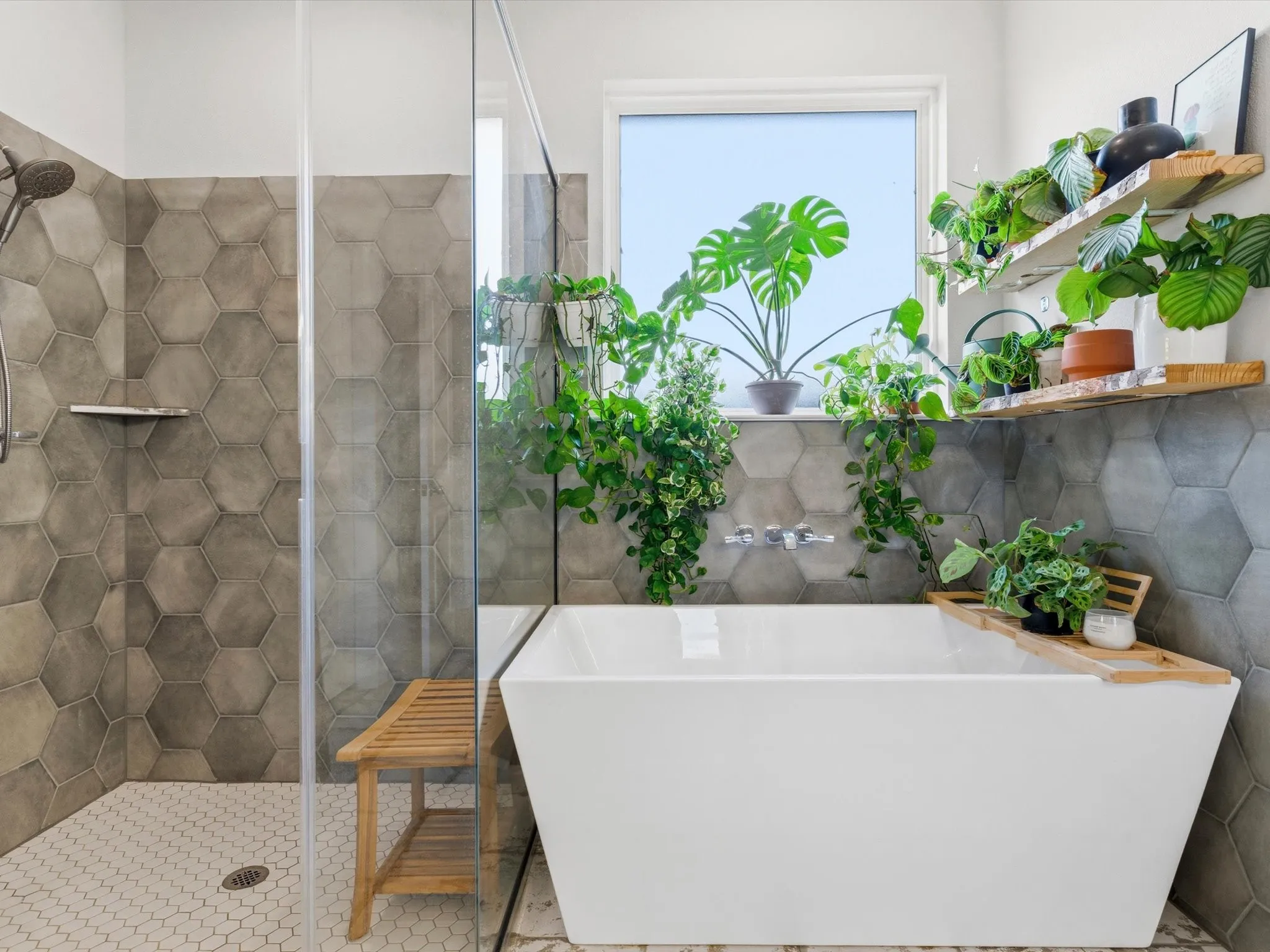 Well-appointed primary bath featuring dual vanities, spacious shower, and functional design.