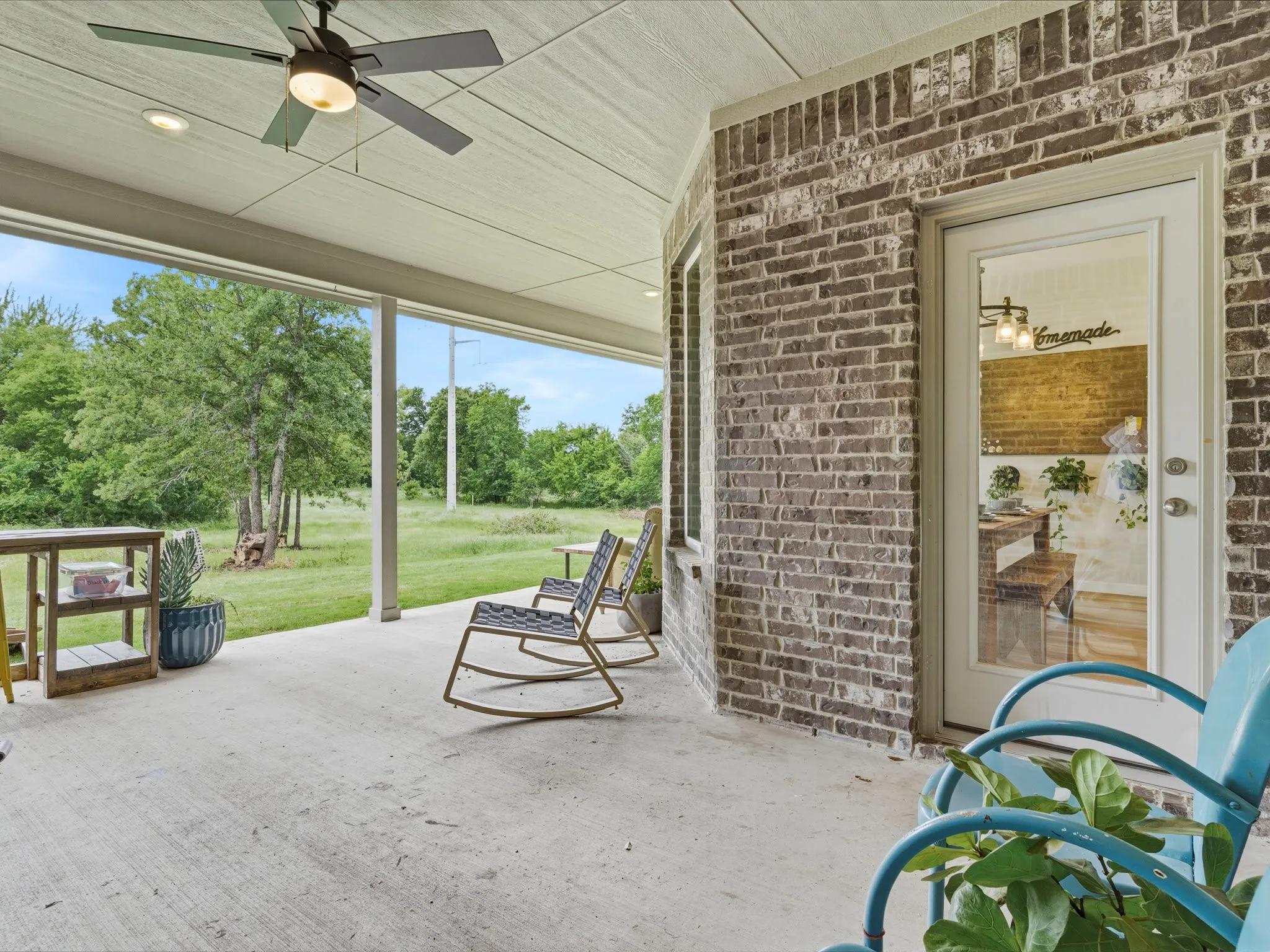 Expansive covered patio designed for outdoor dining, entertaining, and relaxing while enjoying peaceful country views.