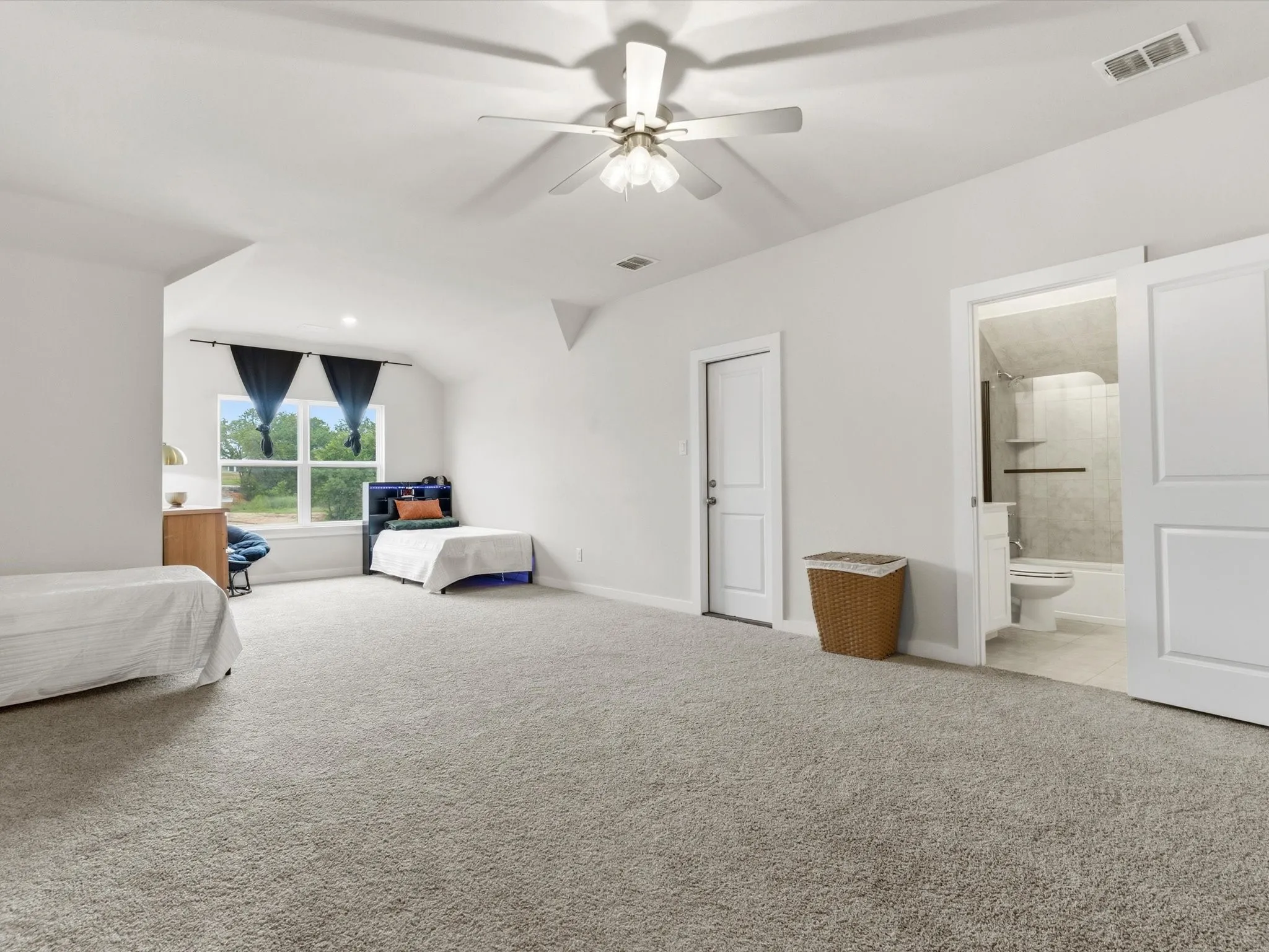 Versatile upstairs suite offering endless possibilities as a media room, game room, second primary suite, or private guest retreat.