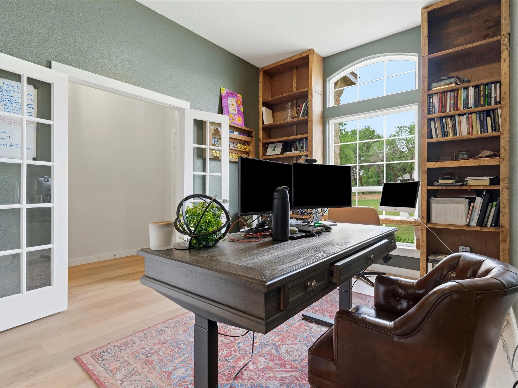 Private executive office with custom built-in cabinetry, ideal for working from home, studying, or managing everyday tasks.