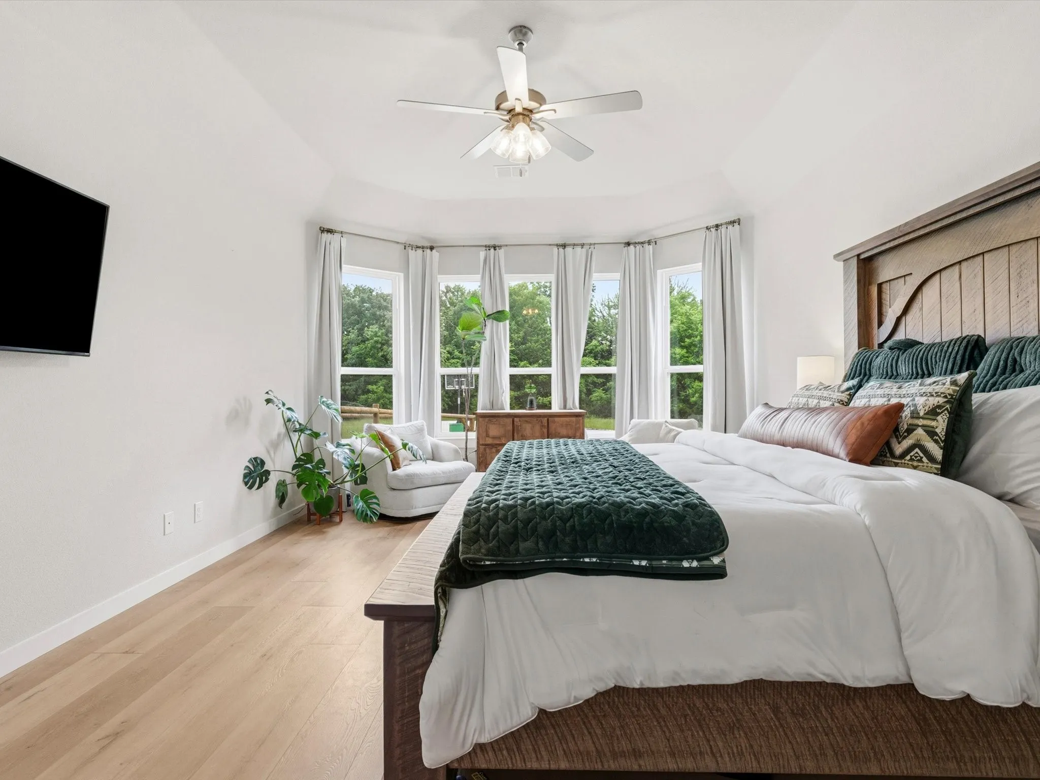 Spacious primary bedroom with abundant natural light and peaceful backyard views.