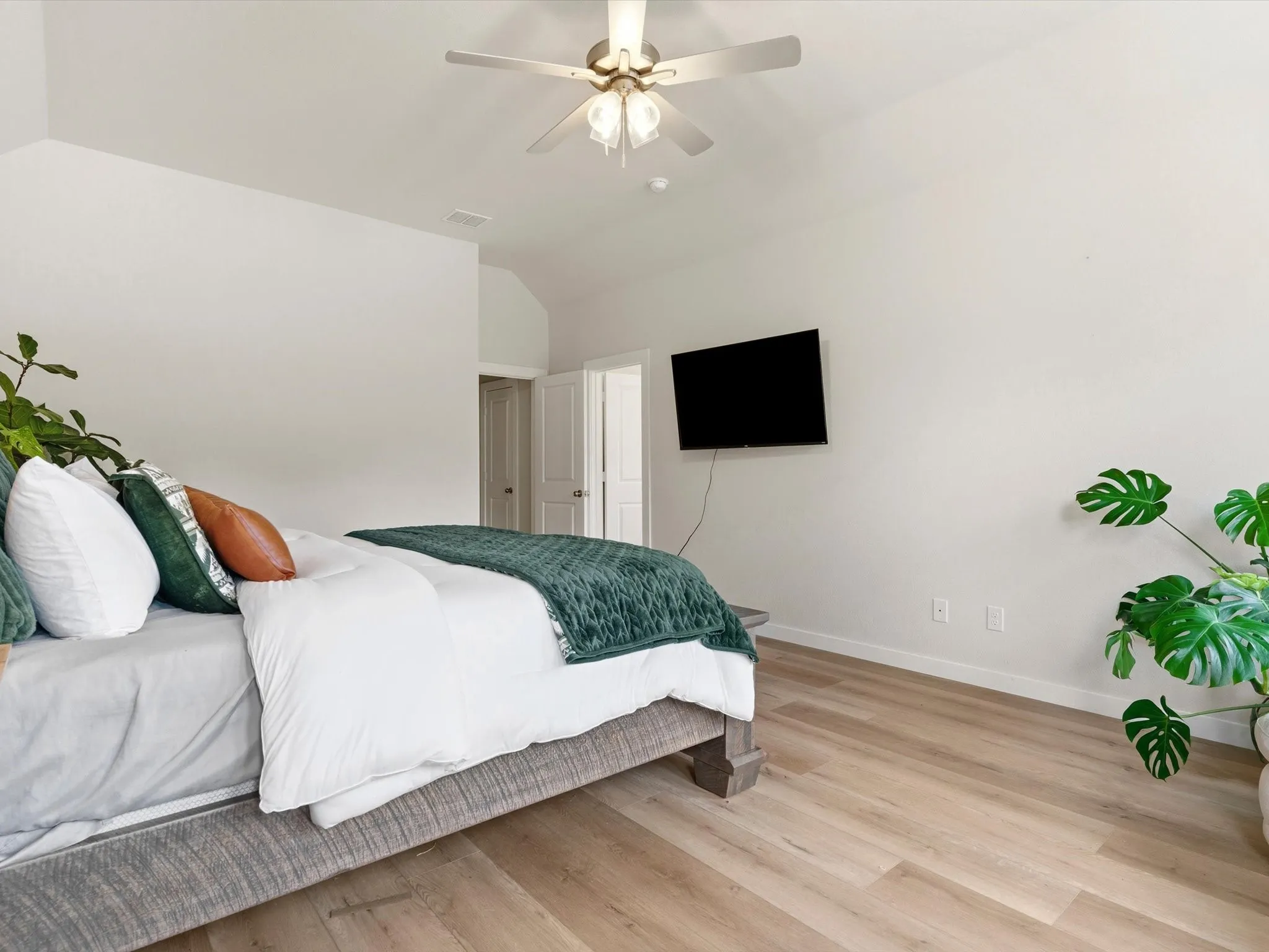 Spacious primary bedroom with abundant natural light and peaceful backyard views.