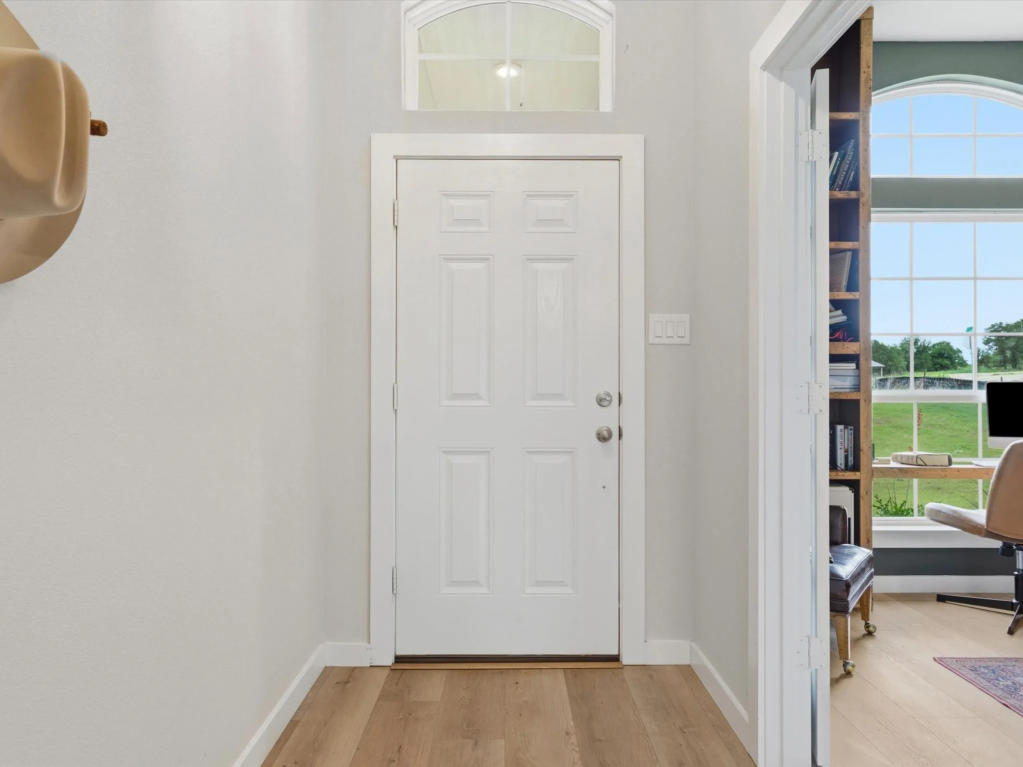 Welcoming foyer featuring abundant natural light and an inviting transition into the open-concept living spaces.
