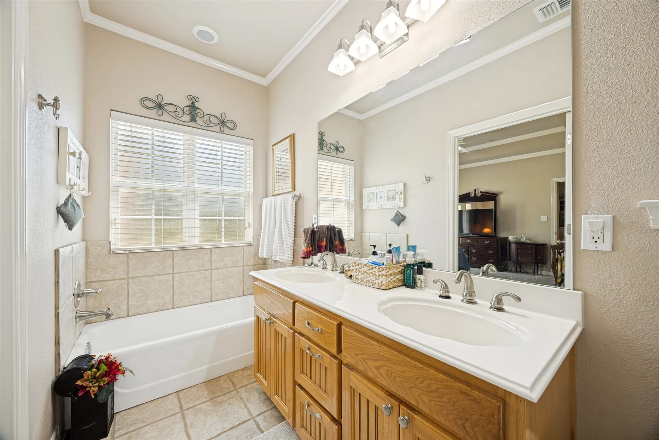 Second primary suite bath has a separate shower and tub and a walk-in closet.