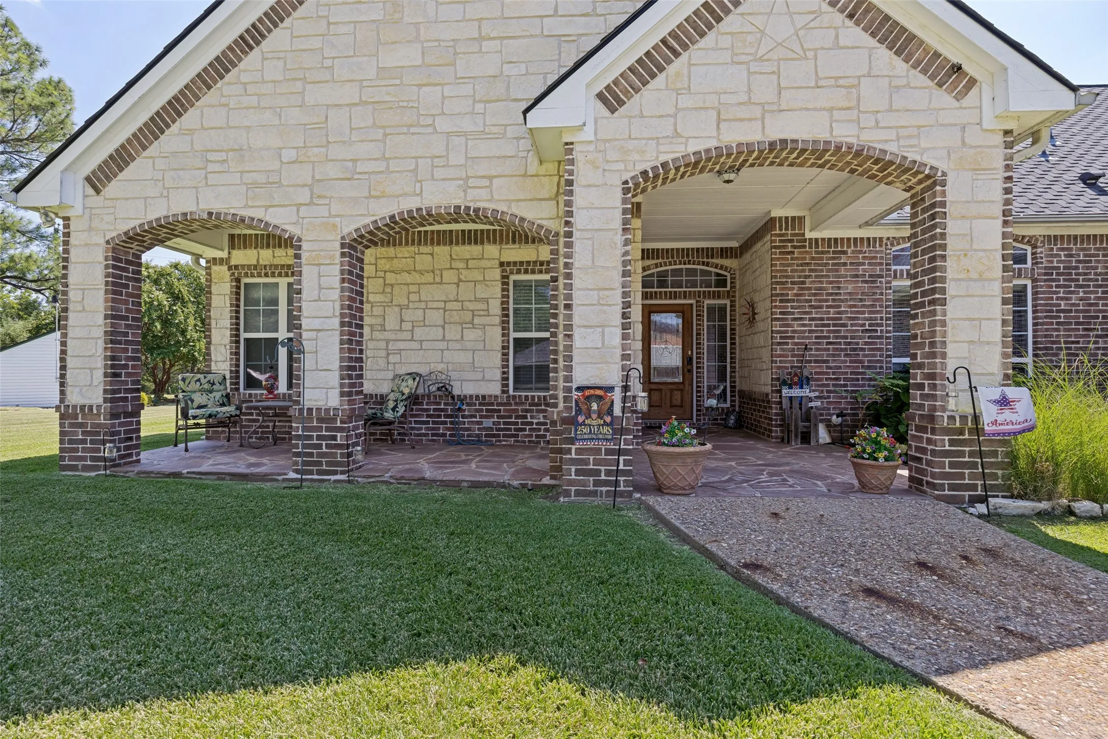The oversized covered front porch also has garden hose access to easily keep your plants watered.