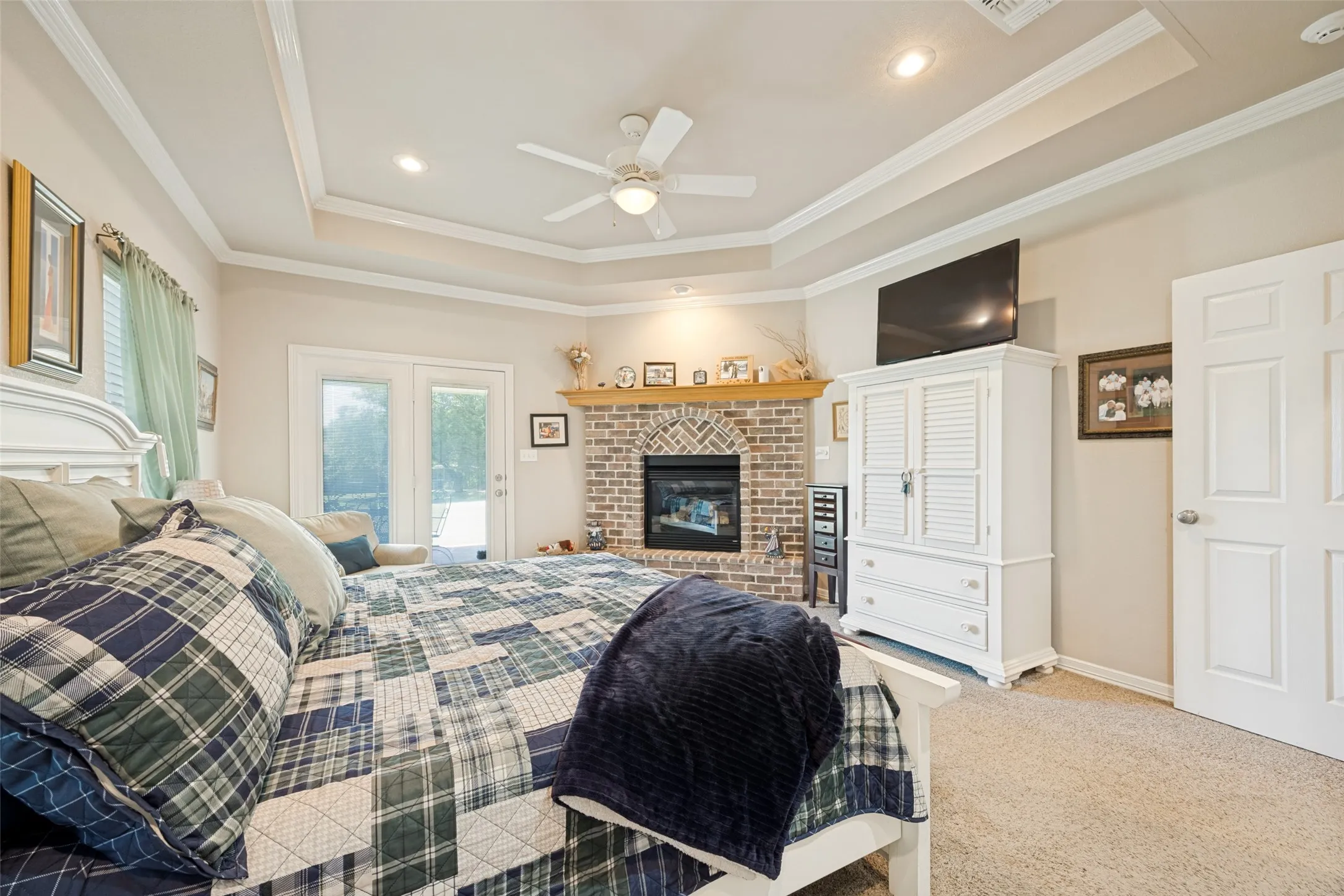 The main primary bedroom has a beautiful fireplace and access to the large patio and outdoor kitchen.