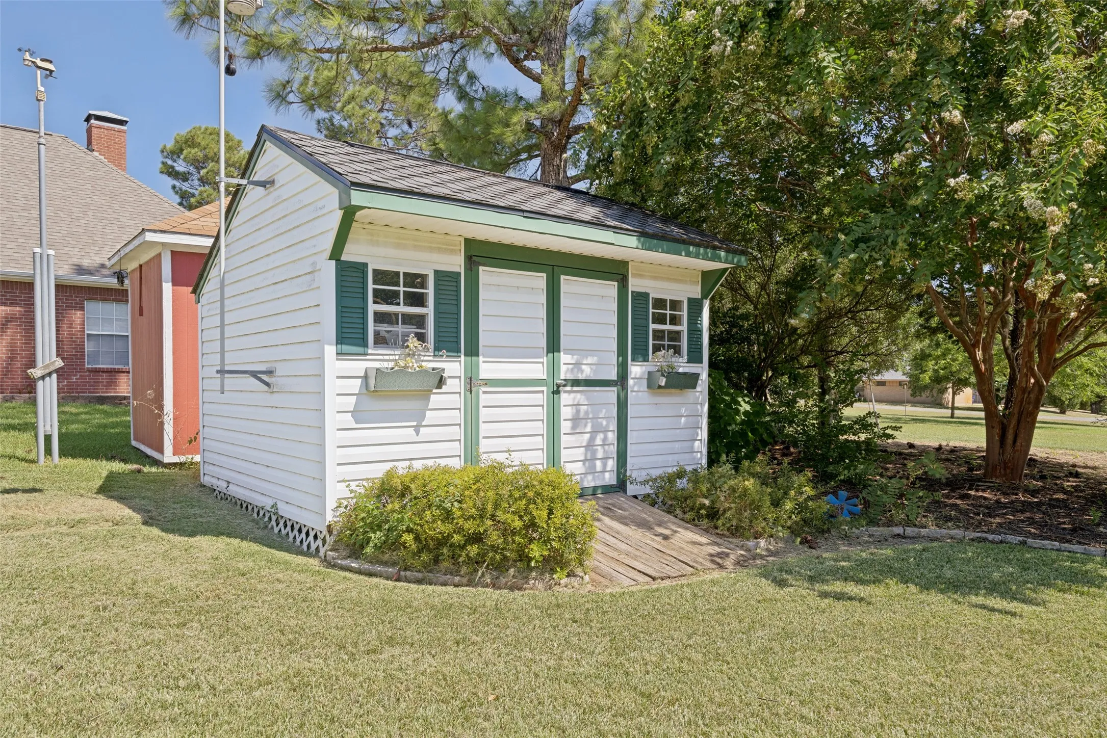 This sweet little shed is ready for your yard equipment. It would also make a great playhouse or garden shed!