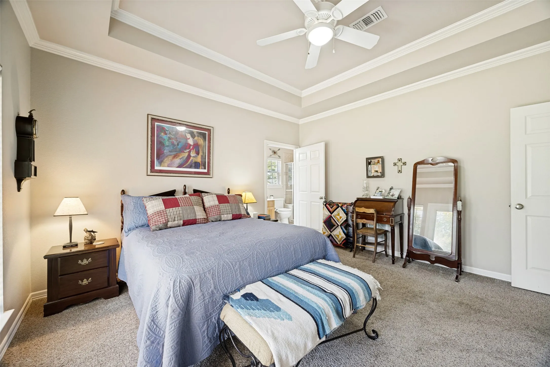 View of the second primary bedroom showing the en suite bathroom where you will find another walk-in closet.