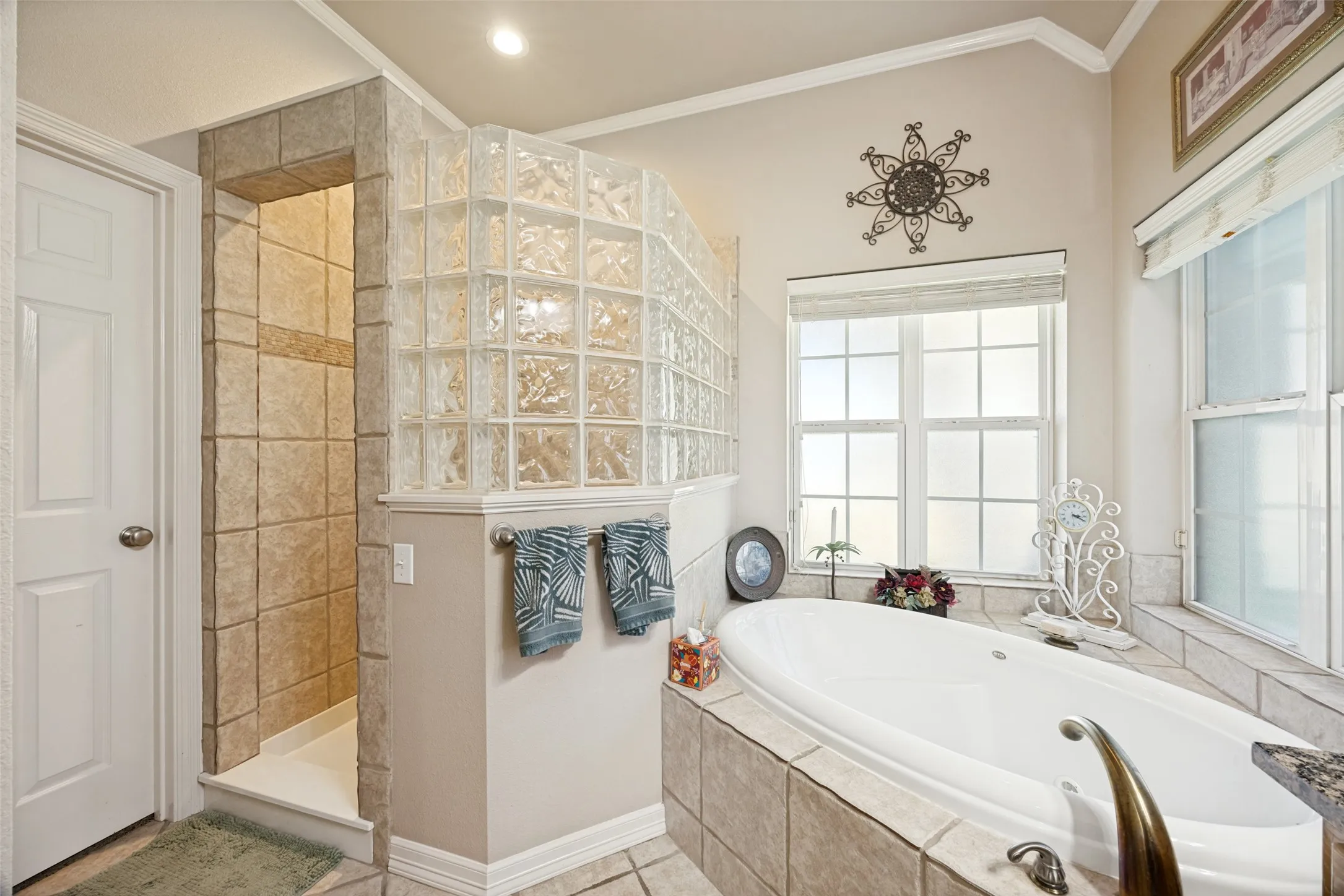 The primary bathroom features a large walk-in shower and garden tub and leads to the large walk-in closet.