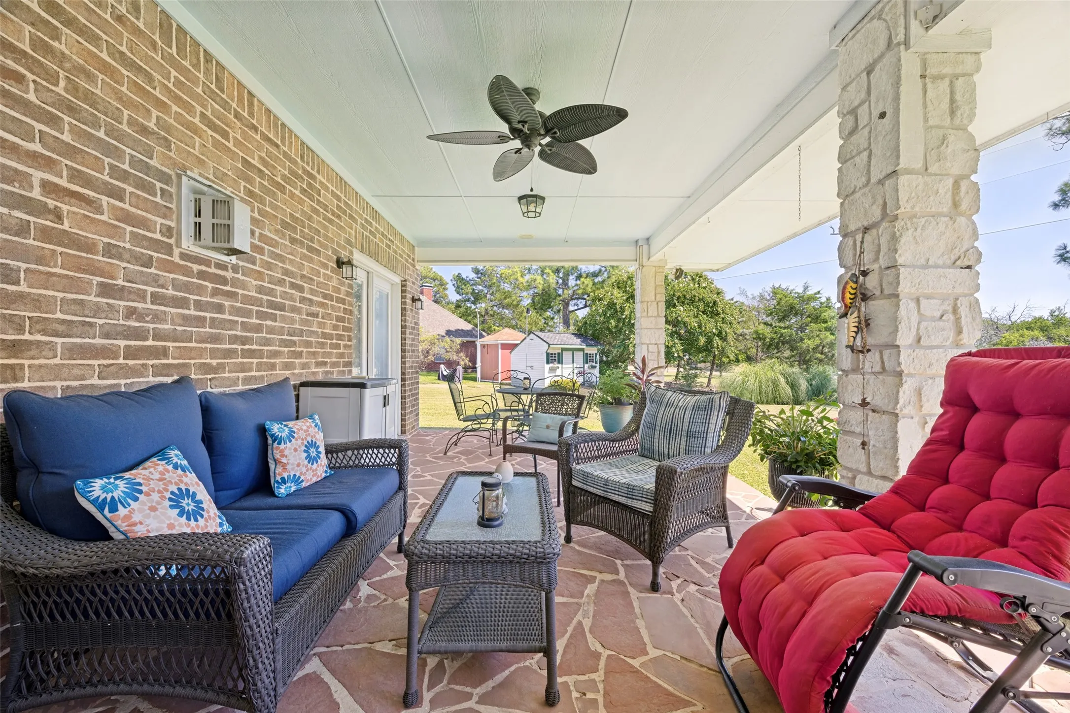 The large back patio has a lovely view of the large backyard.