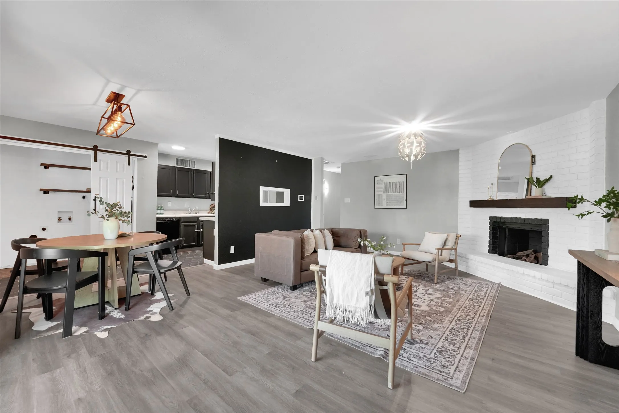 Open-concept living space with wood-finish flooring
