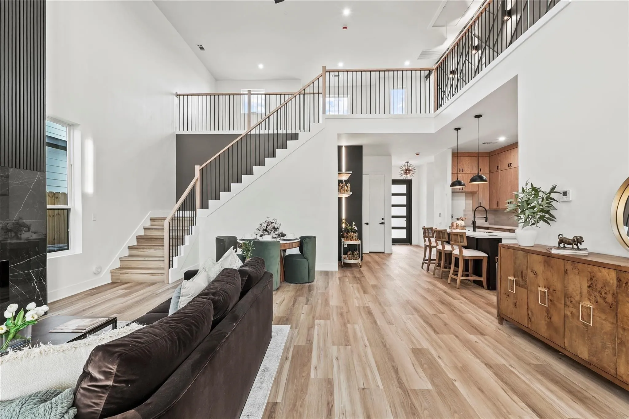Open-concept interior featuring high ceilings and wood-finish flooring