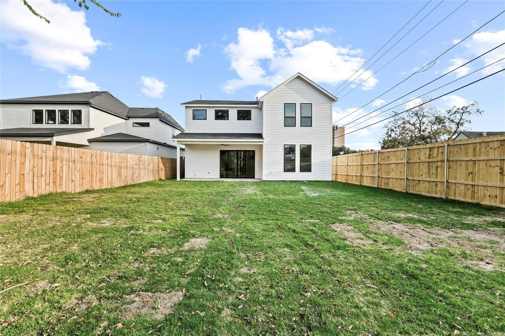 White clapboard-style siding with black-framed windows