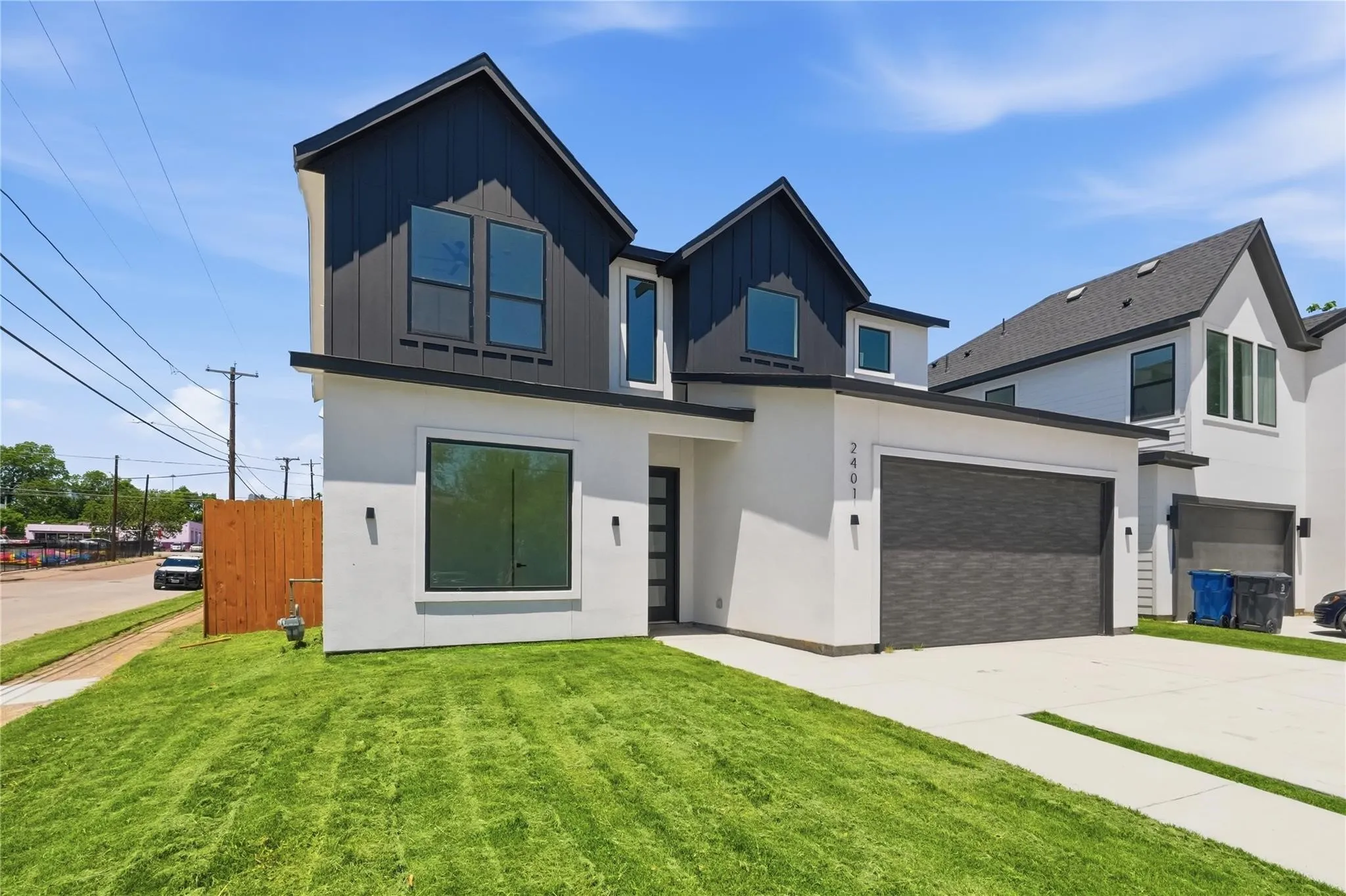 Contemporary two-story exterior with a contrasting dark gray facade and white stucco