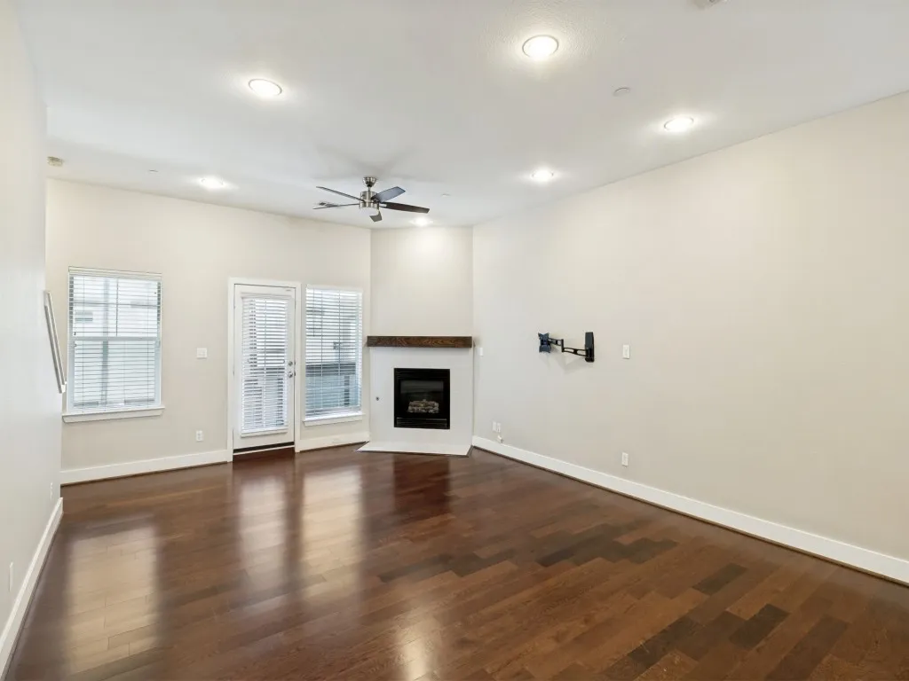 Living room features a cozy fireplace and small 2nd floor balcony