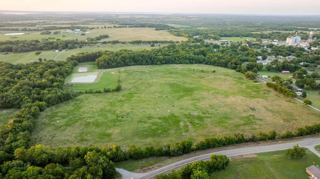 SE view of property, showing cattle in pasture.  The two ponds are Windom Sewage Treatment Plant and Windom Cemetery in upper left corner of photo.