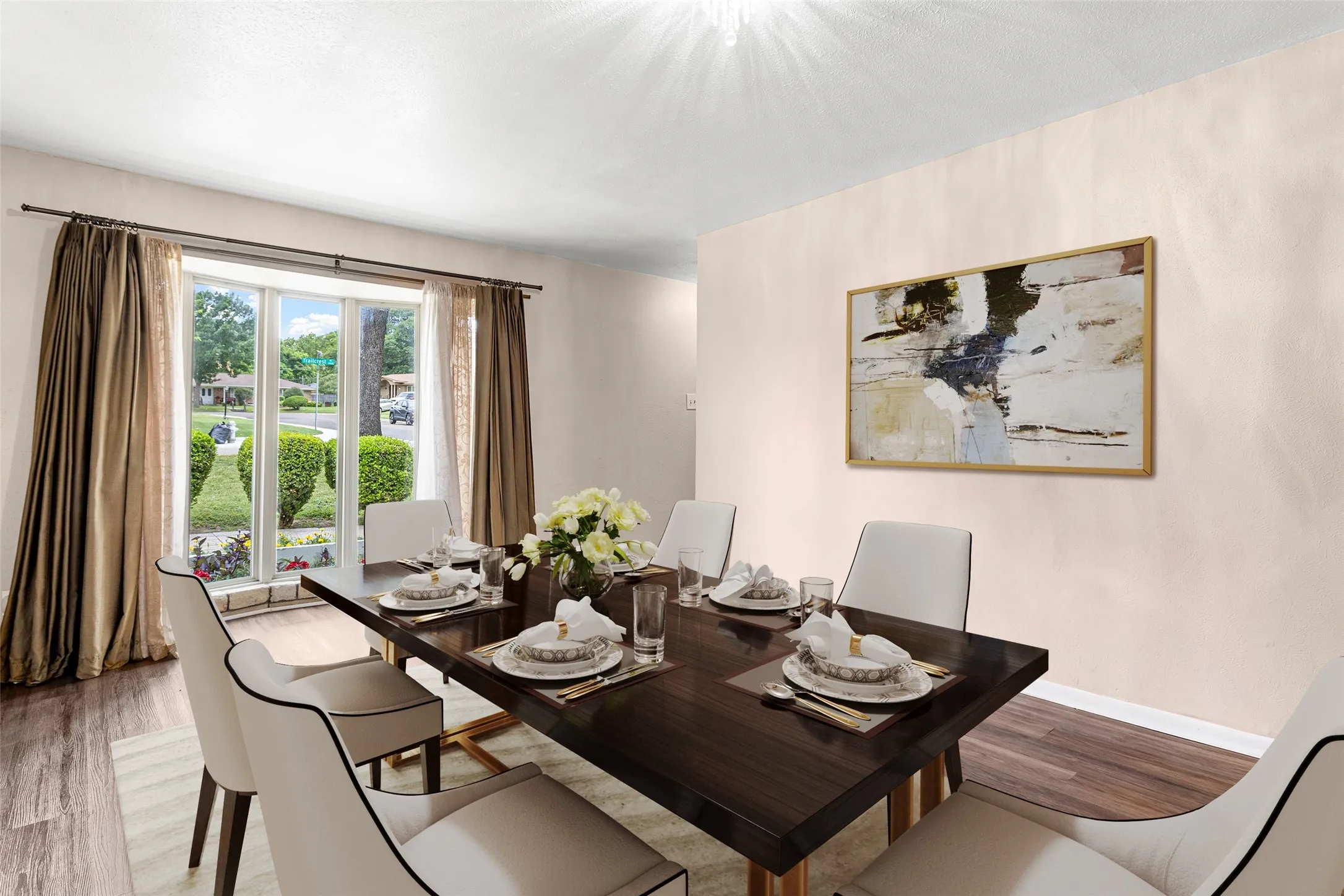Virtually Staged Dining area featuring wood-finish flooring, a large bay window, and light-colored wall finishes