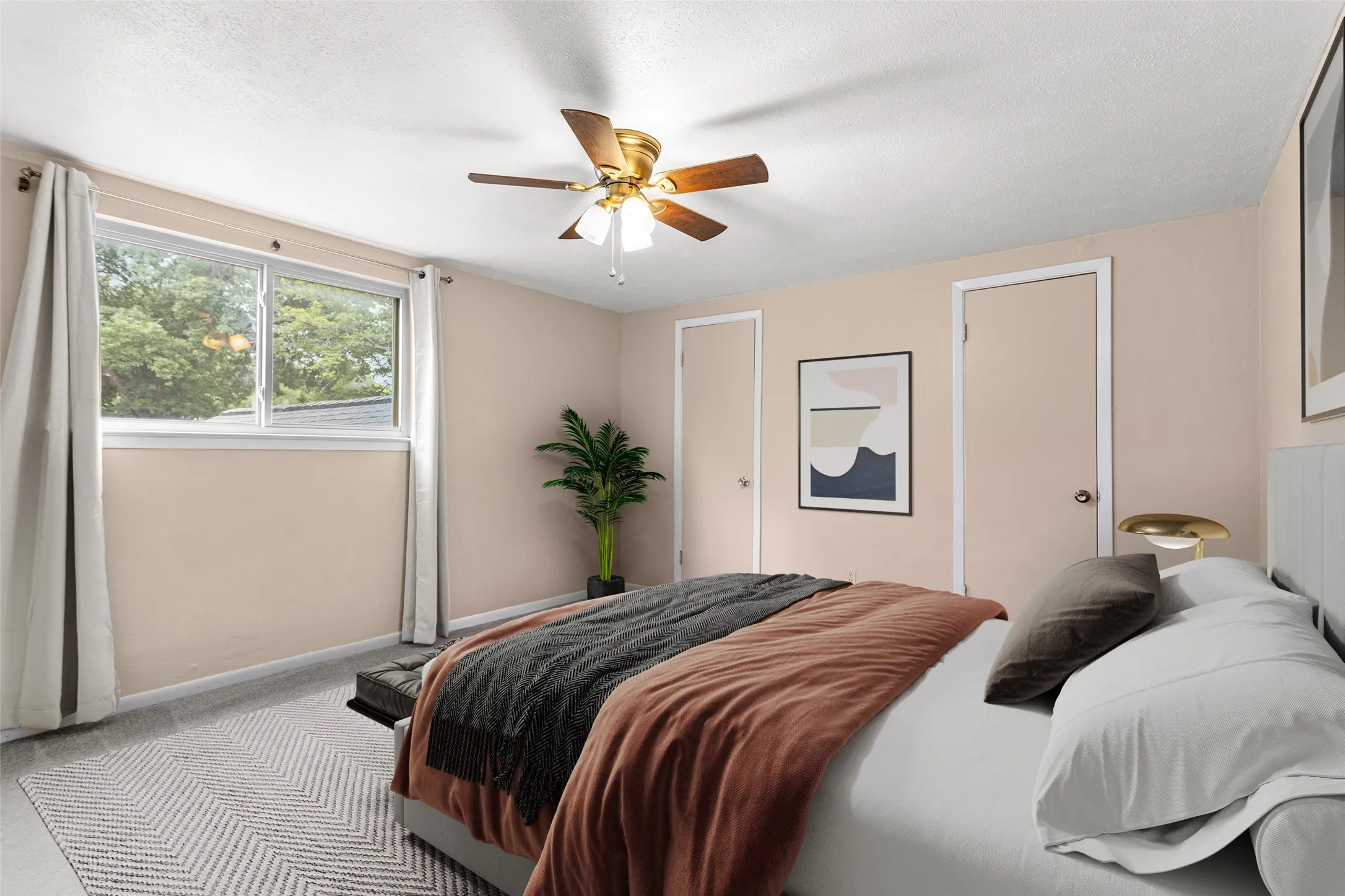 Virtually Staged Interior room featuring a ceiling fan with integrated lighting, wood-finish flooring, and a large window