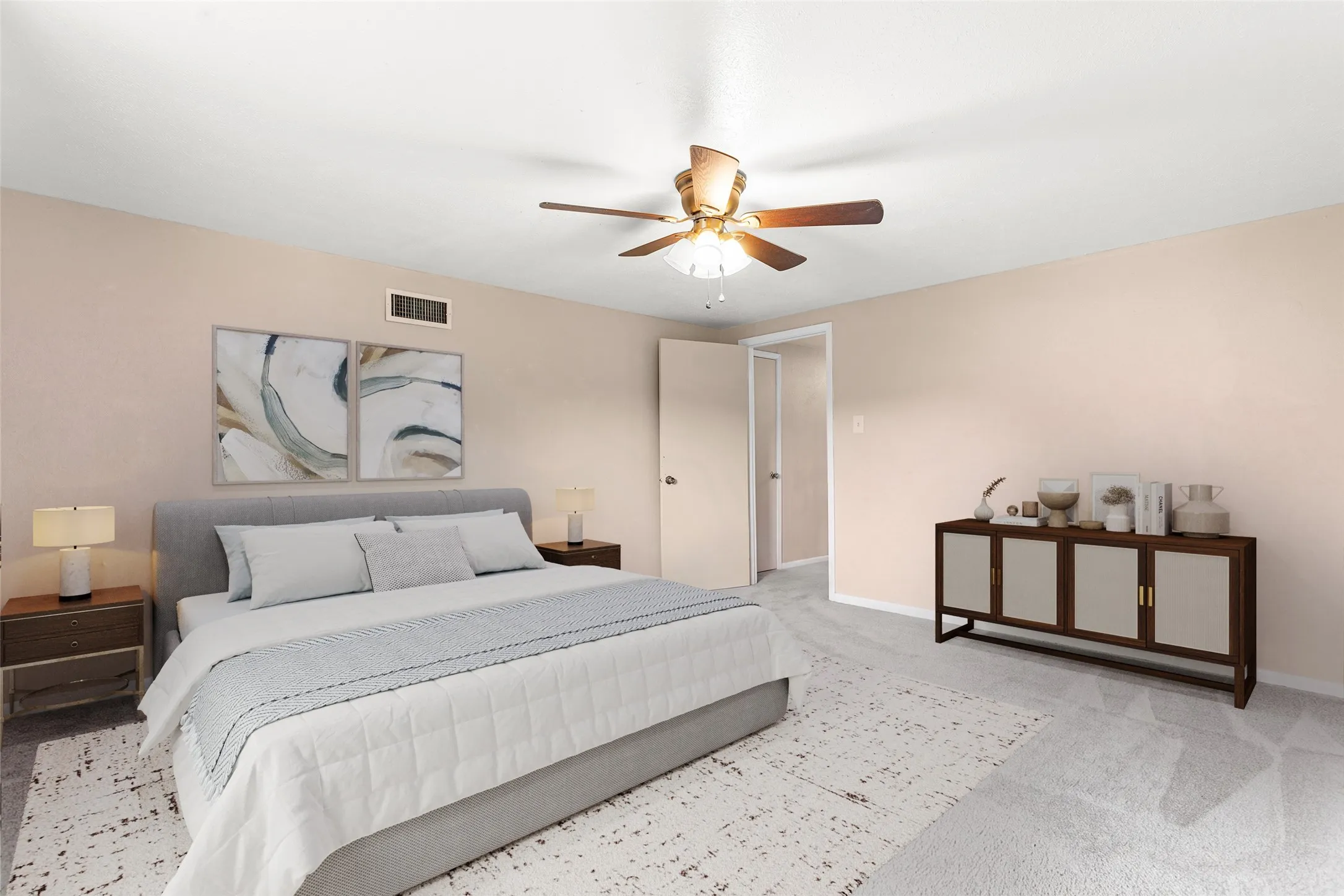 Virtually Staged Spacious bedroom featuring light-colored walls, ceiling fan with integrated lighting, and soft carpeting