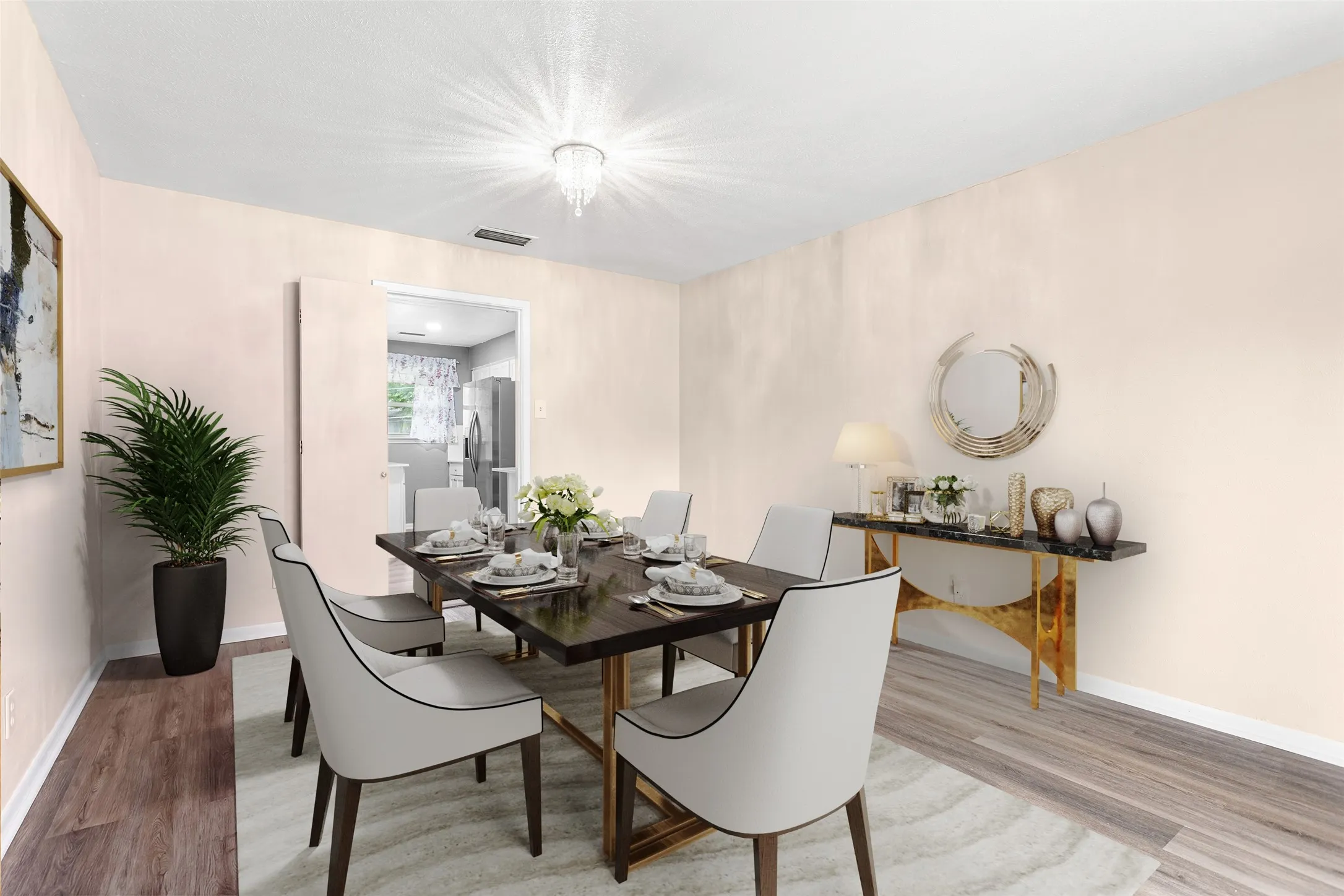 Virtually Staged Formal dining area featuring wood-finish flooring, a contemporary chandelier, and an open doorway to the kitchen