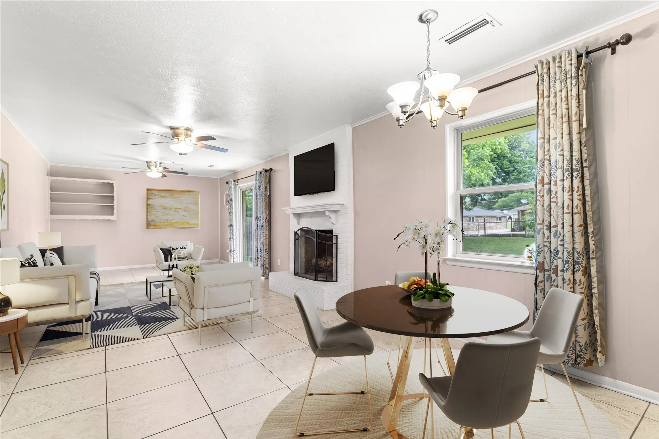 Virtually Staged Expansive open-concept living area featuring tile flooring, a white brick fireplace with a mantel, built-in shelving, and multiple windows allowing natural light